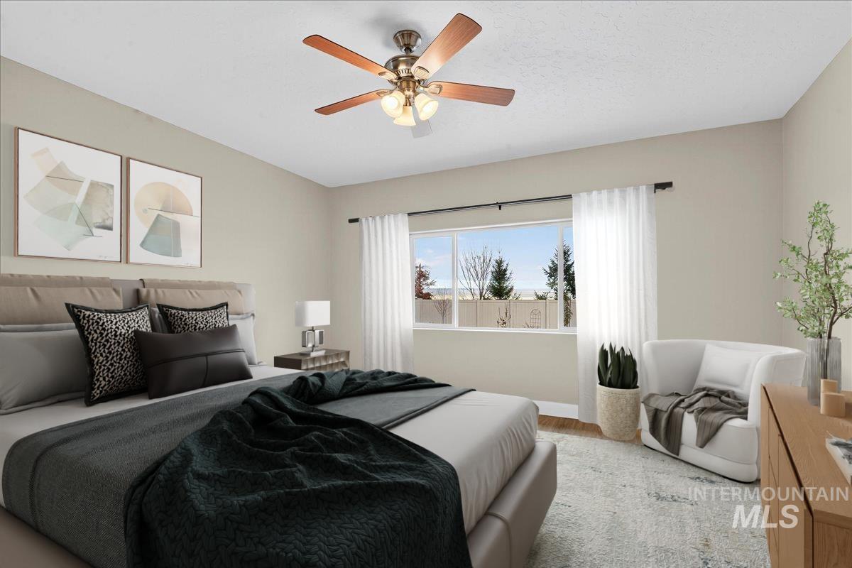 Bedroom featuring wood finished floors and ceiling fan