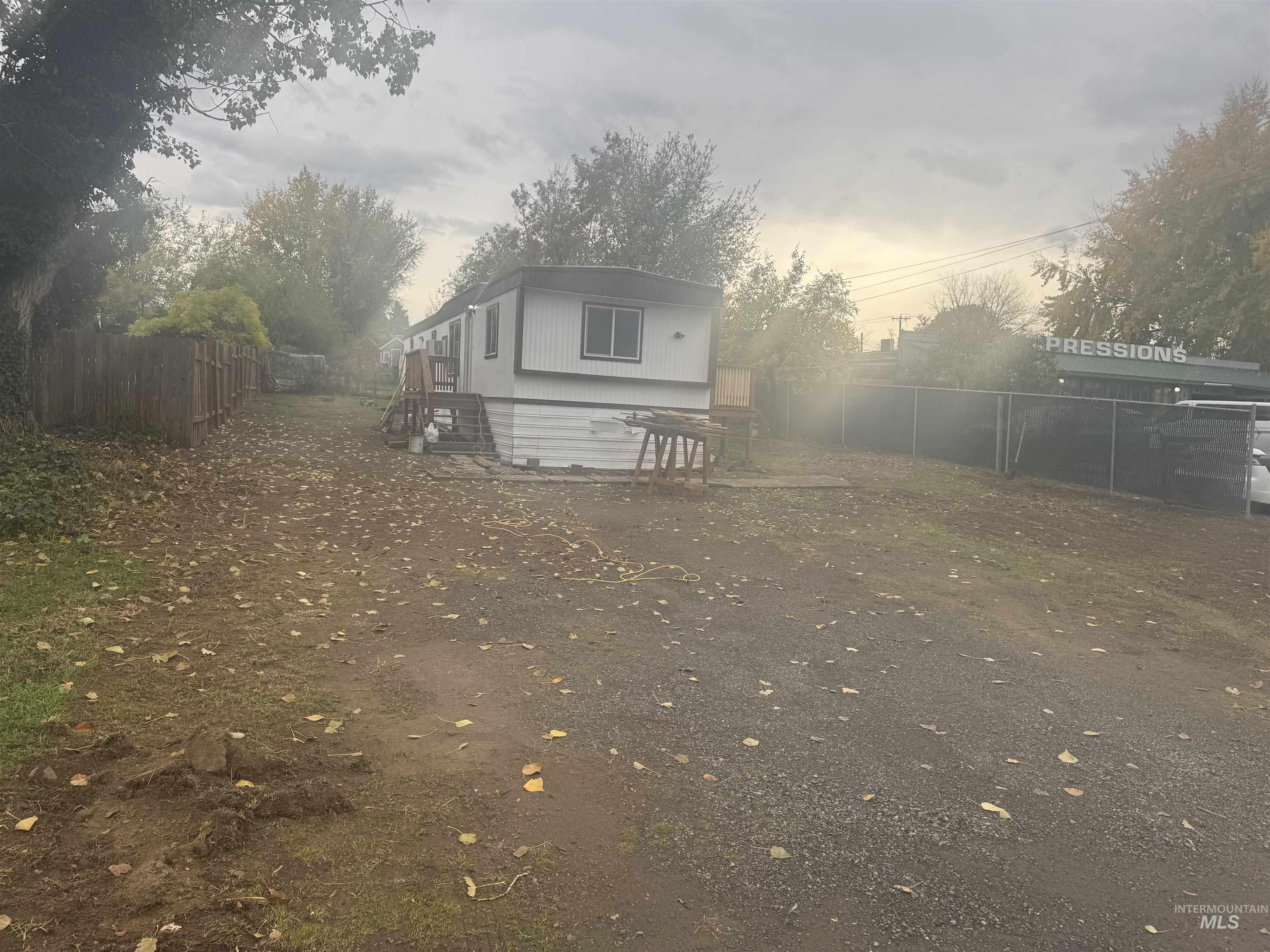 Rear view of house featuring a fenced backyard