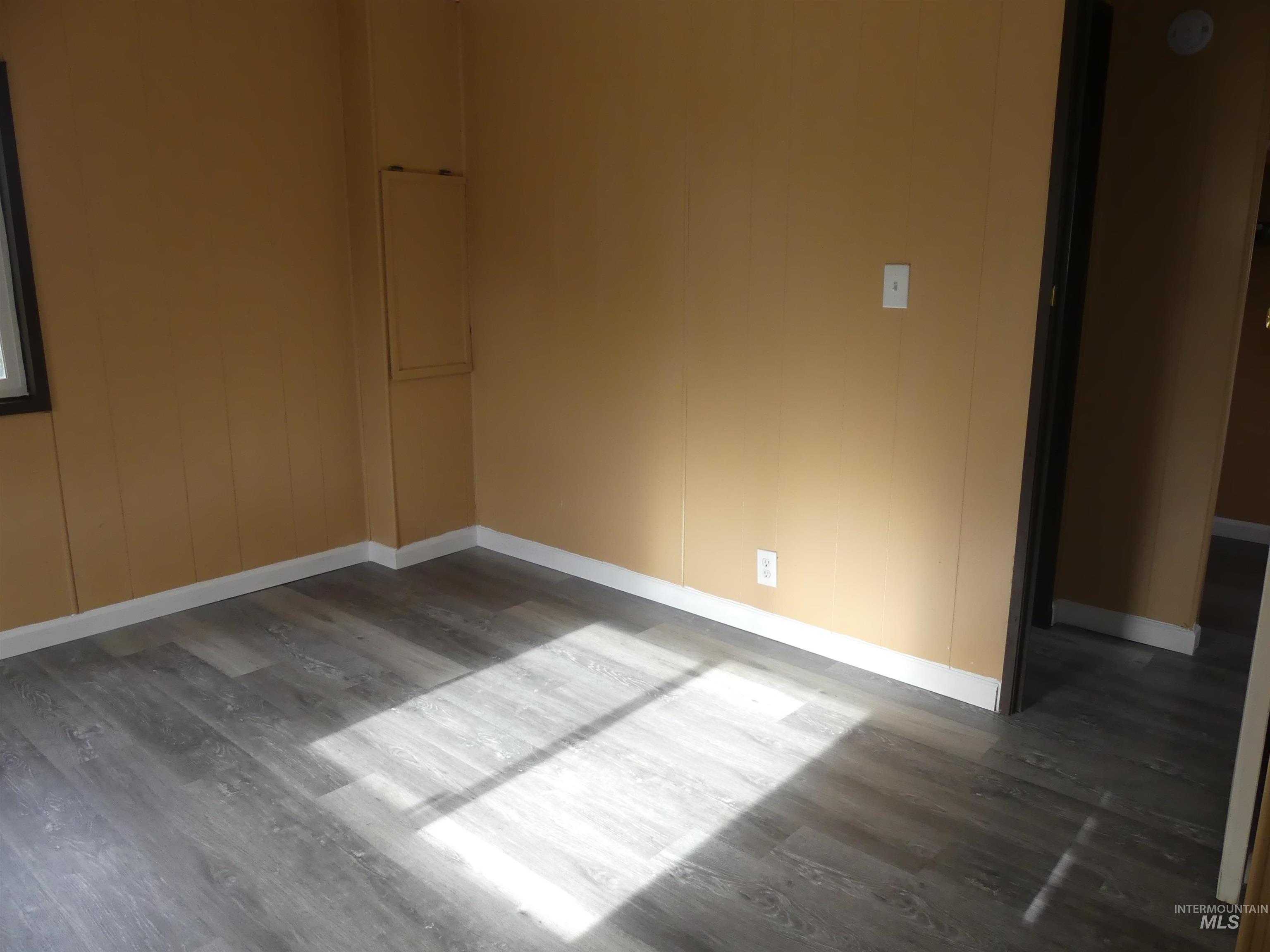 Empty room with wood finished floors and baseboards