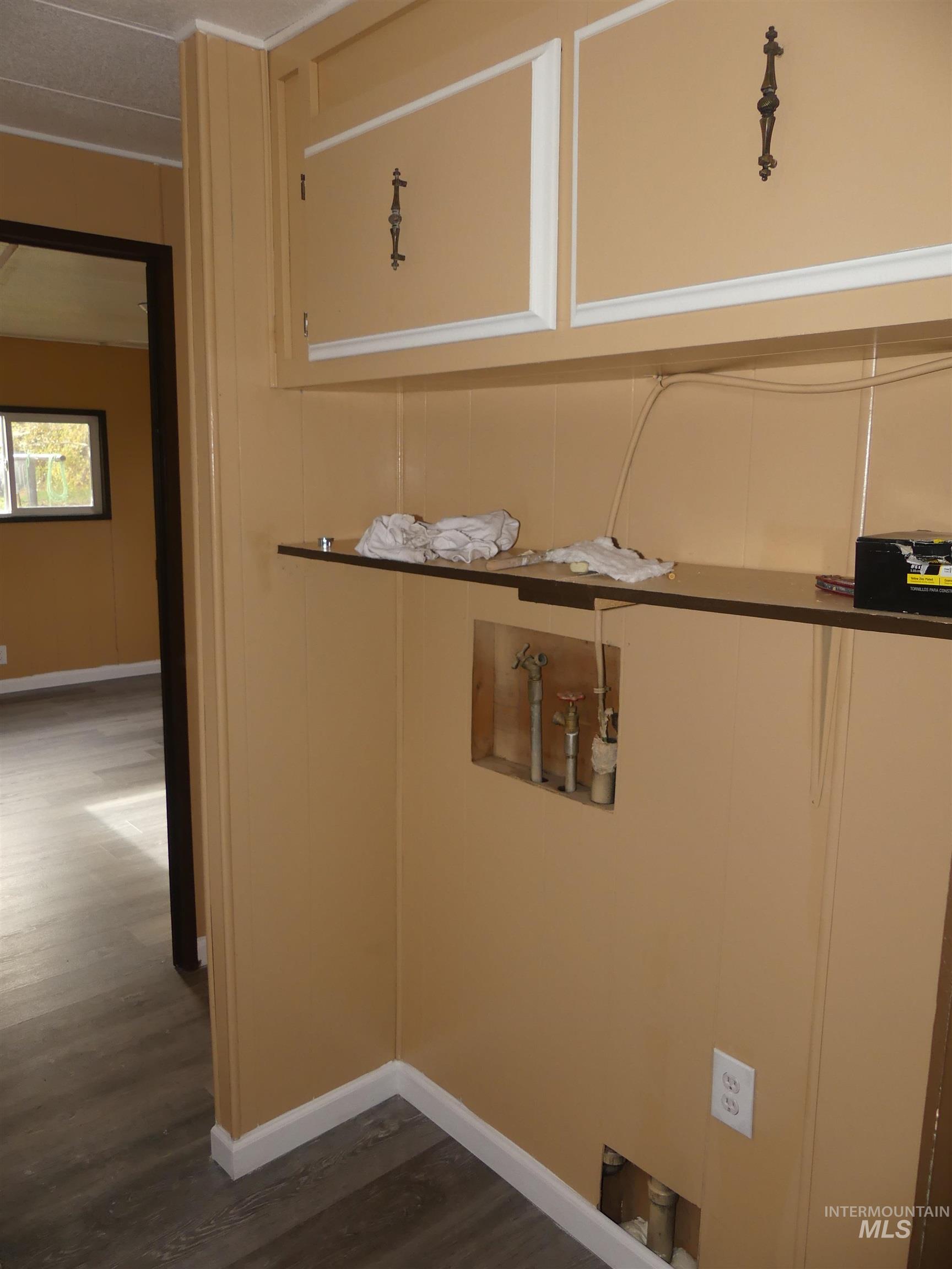 Washroom featuring washer hookup and dark wood-type flooring