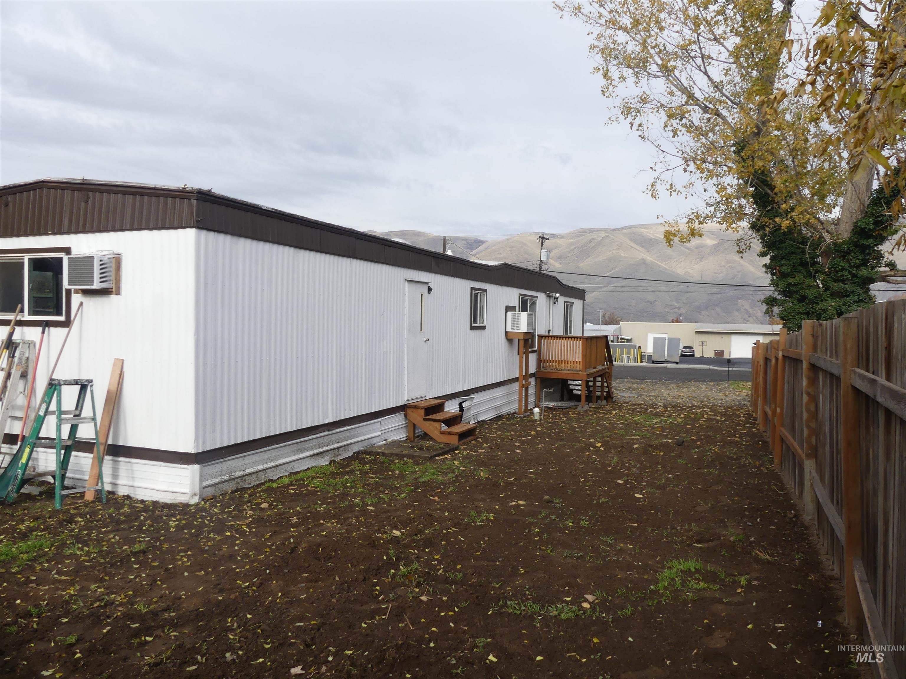 View of side of home featuring a deck with mountain view