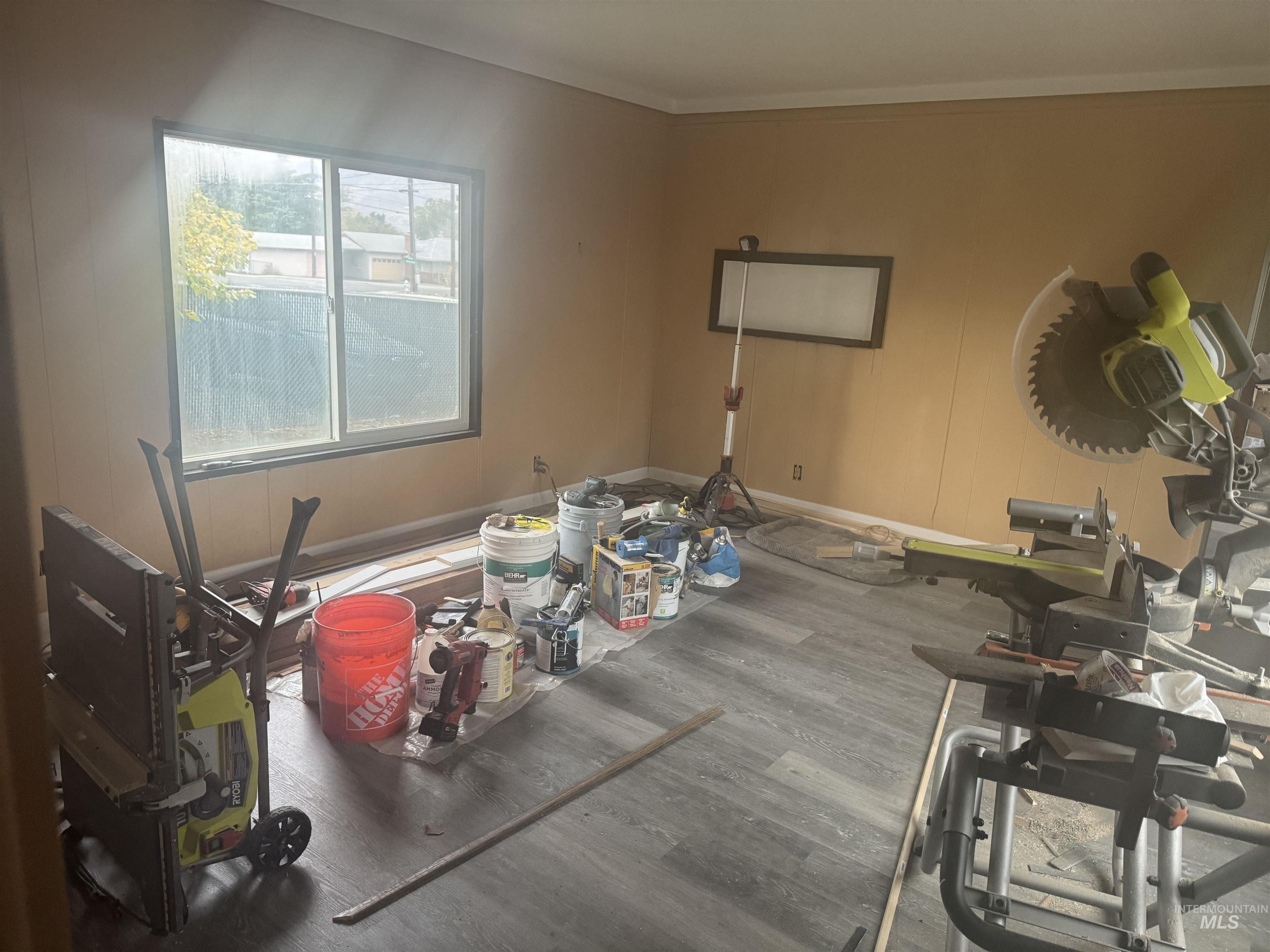 Dining area with wood finished floors and ornamental molding