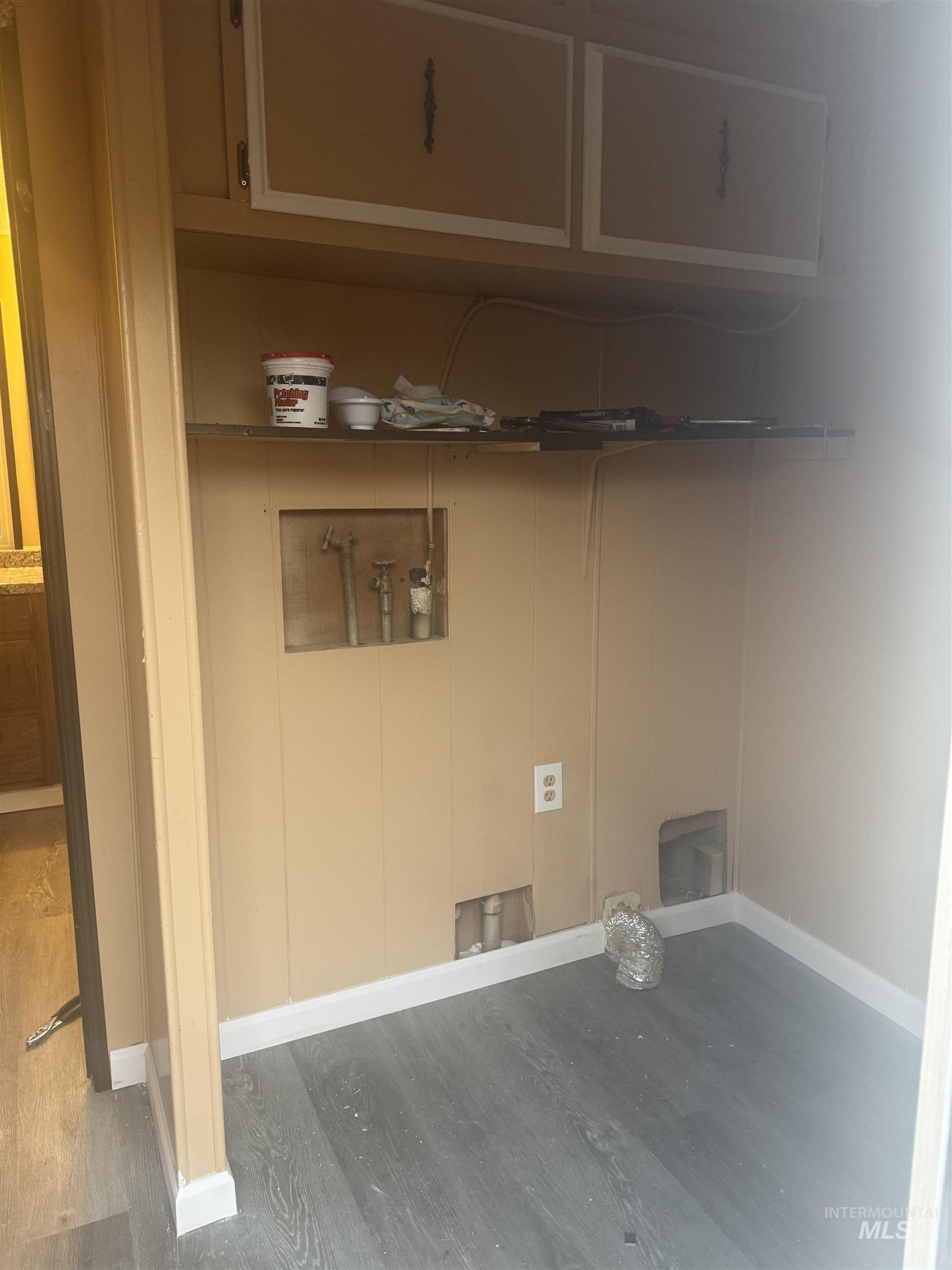 Laundry room featuring dark wood-style flooring and hookup for a washing machine