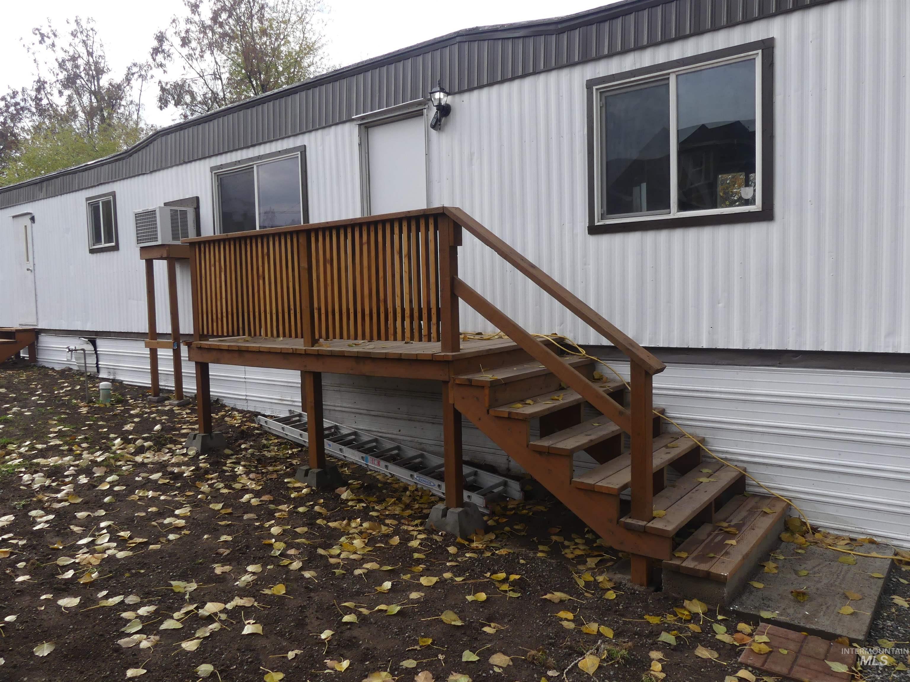 Wooden terrace featuring a wall mounted air conditioner