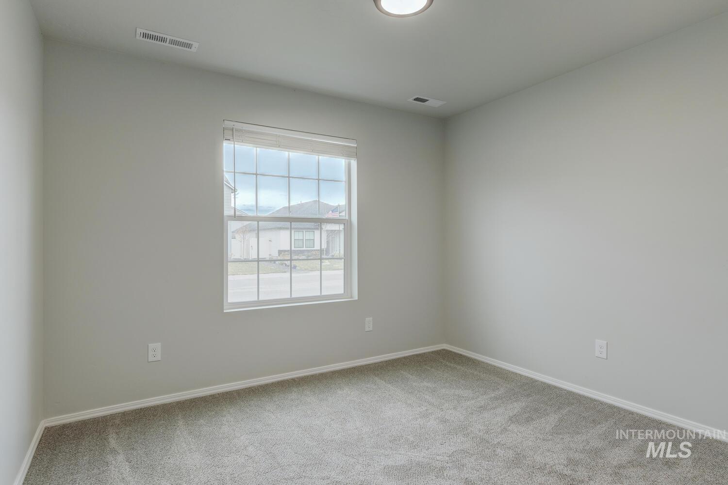 Spare room with light colored carpet