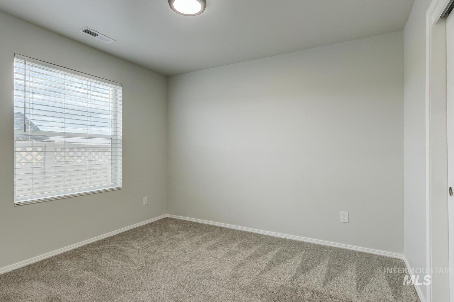 Unfurnished room with carpet floors and baseboards