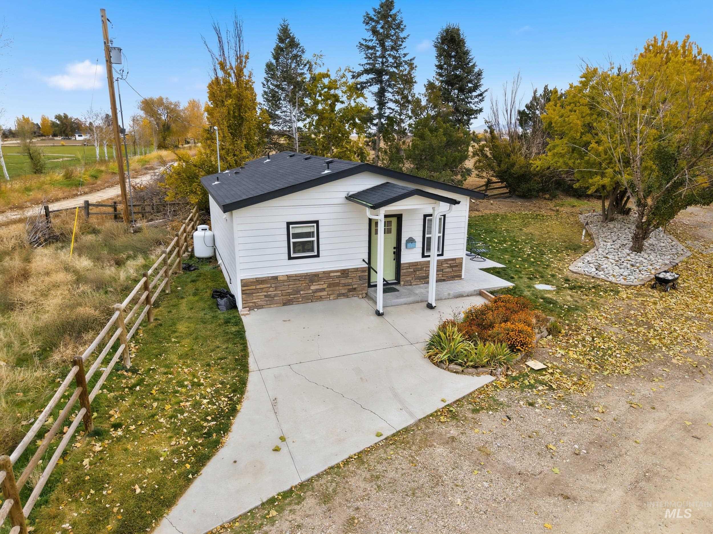 Bungalow with stone siding and a patio