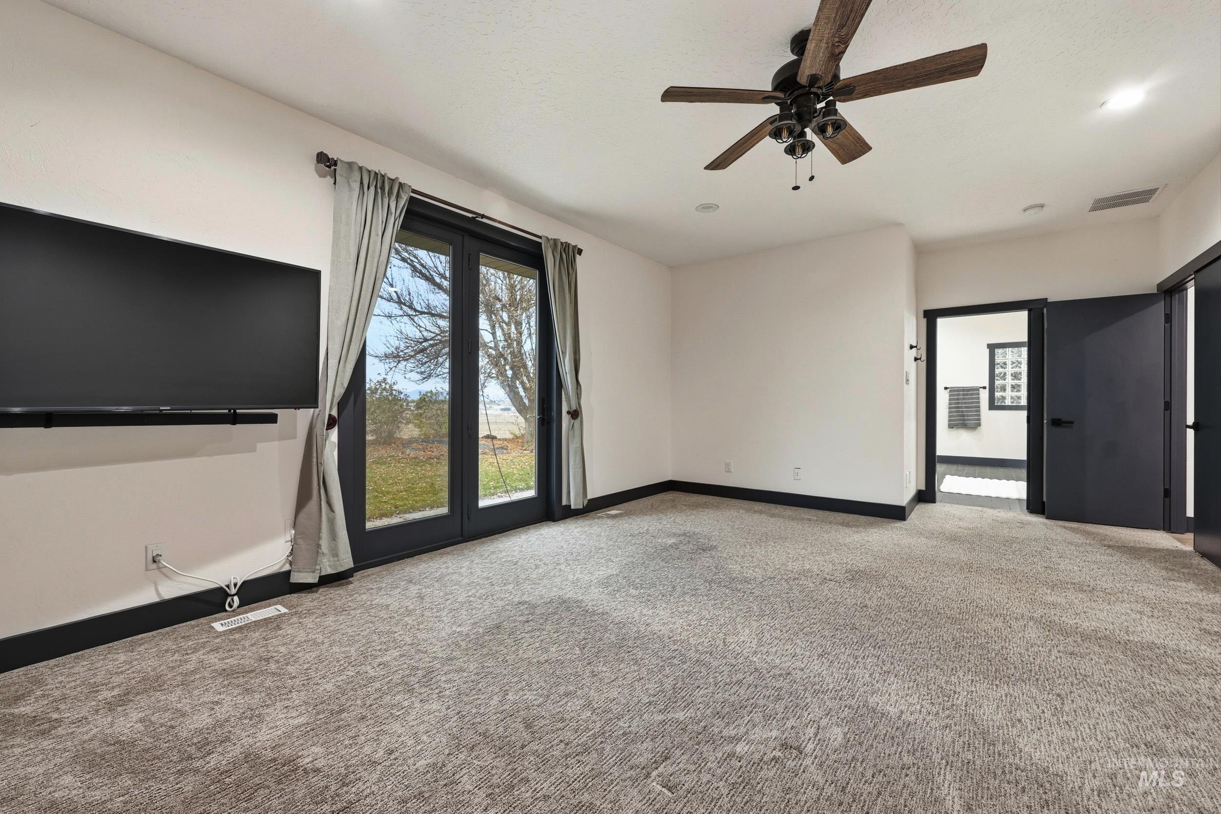 Unfurnished living room with light carpet, a ceiling fan, and recessed lighting