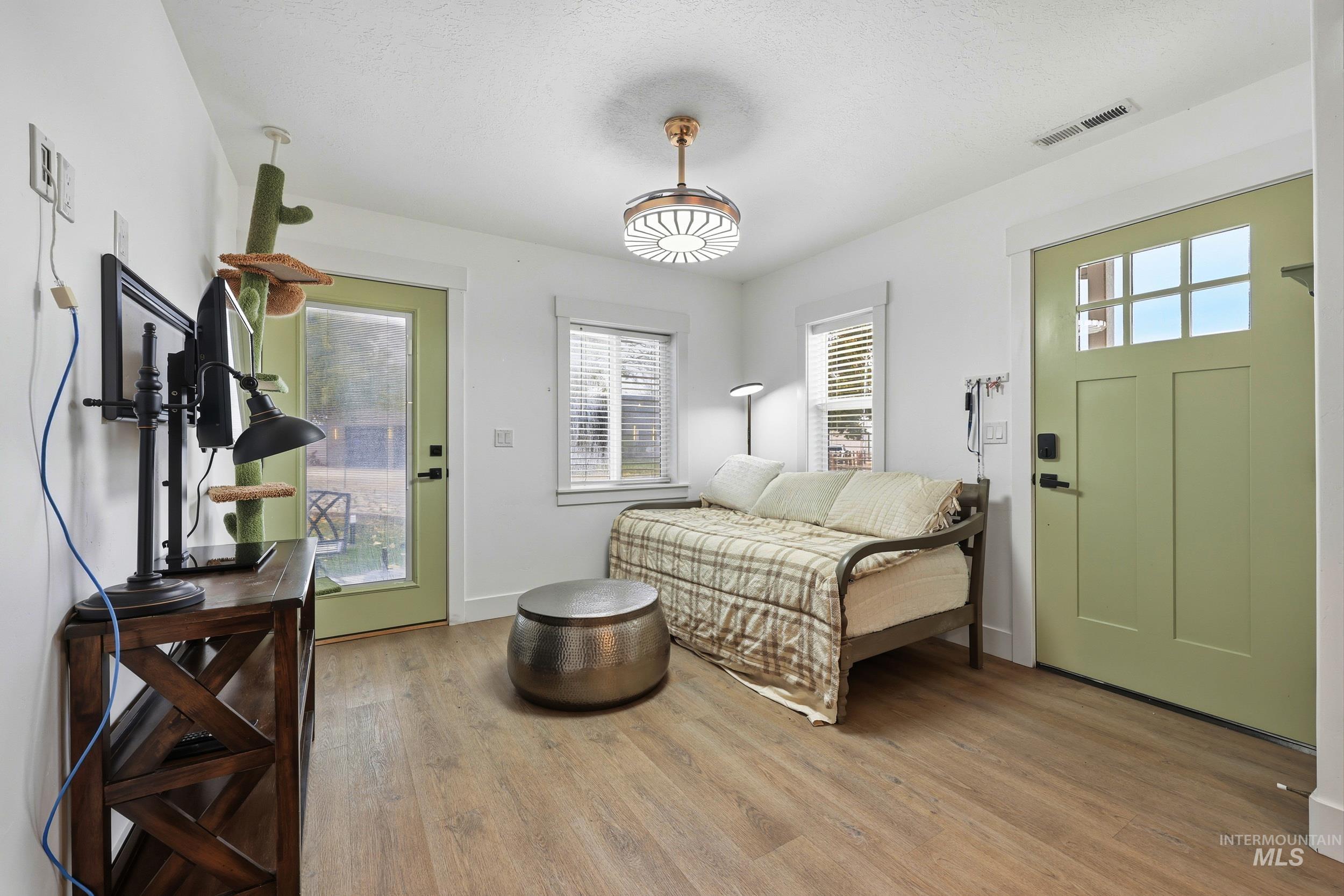 Bedroom with light wood-style floors and access to outside
