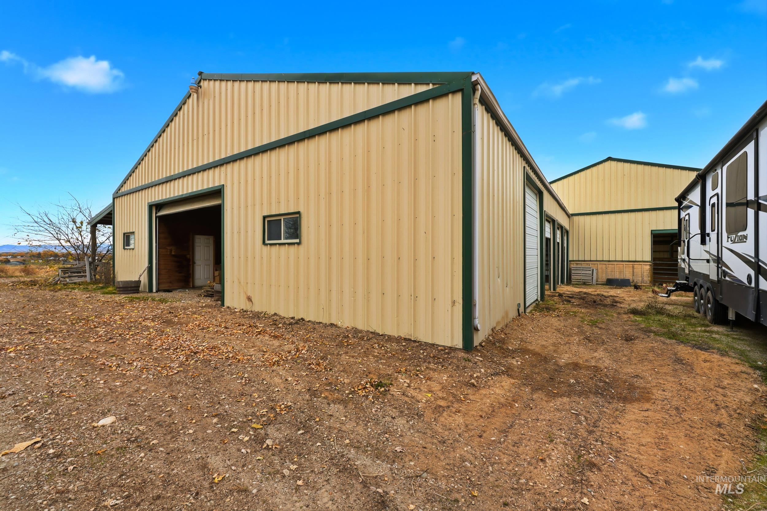 View of side of home featuring an outbuilding, an outdoor structure, and board and batten siding