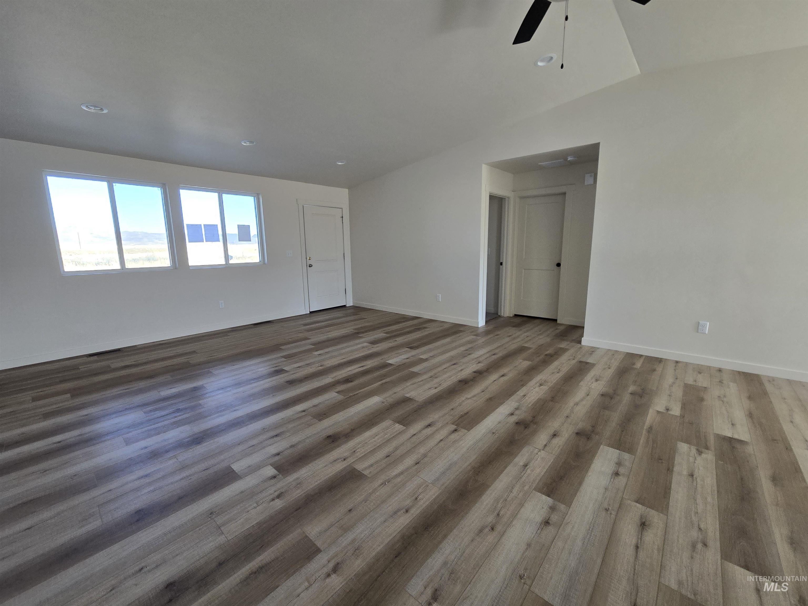 Unfurnished living room with light wood-style flooring, ceiling fan, and recessed lighting