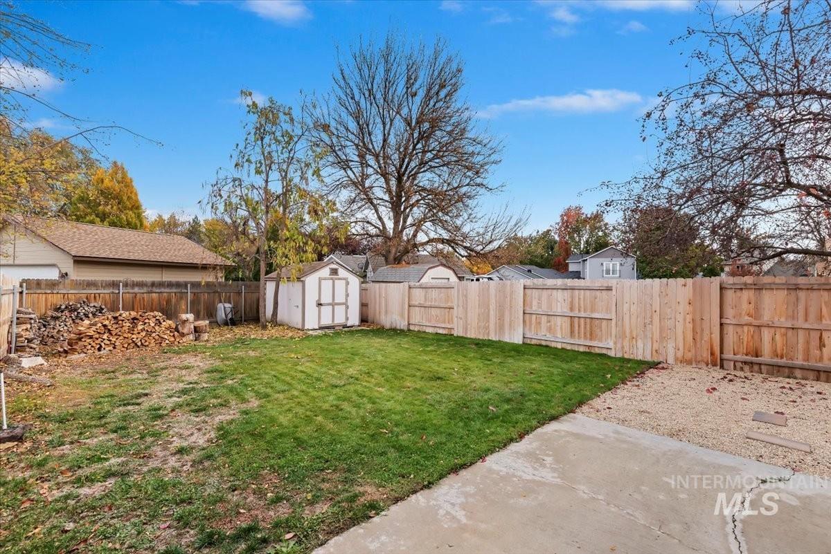 Fenced backyard with a storage shed