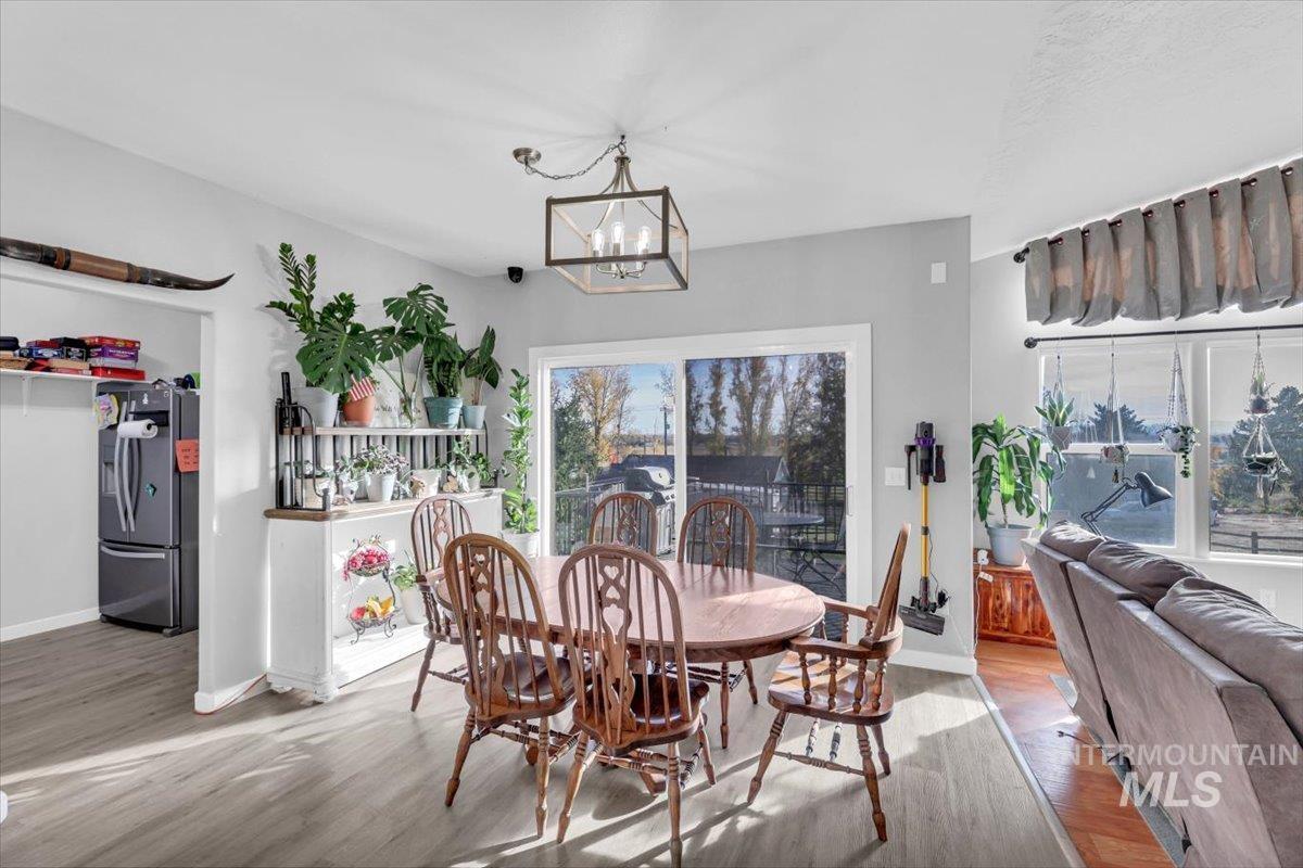 Dining room featuring wood finished floors and a chandelier