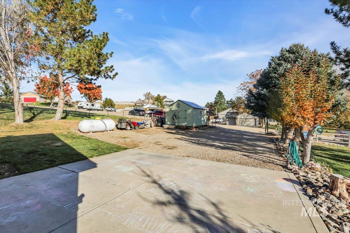 View of yard featuring a patio and an outbuilding