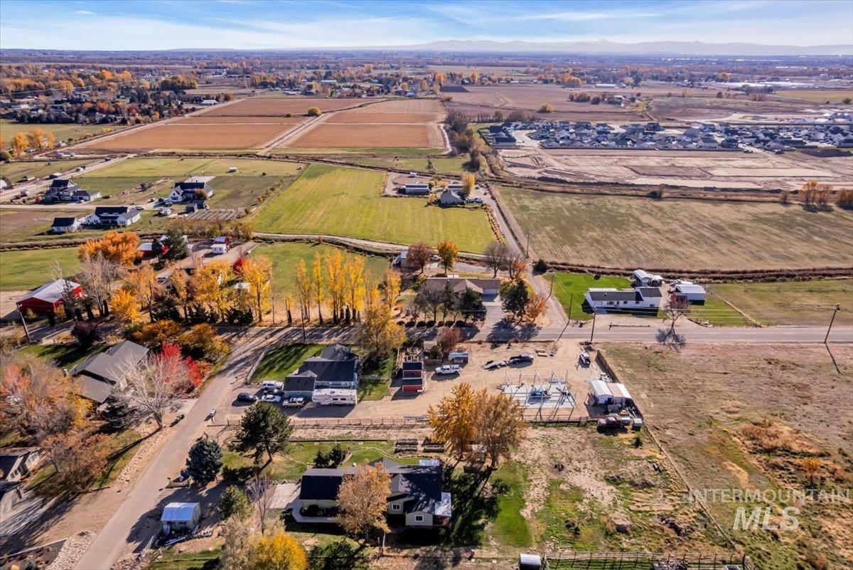 Aerial view of property and surrounding area featuring rural landscape