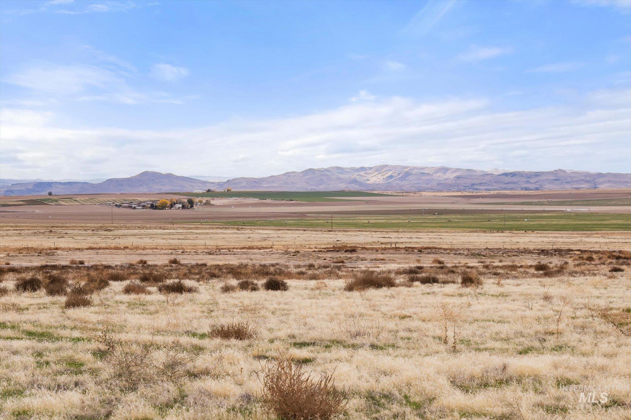 View of mountain backdrop featuring rural landscape