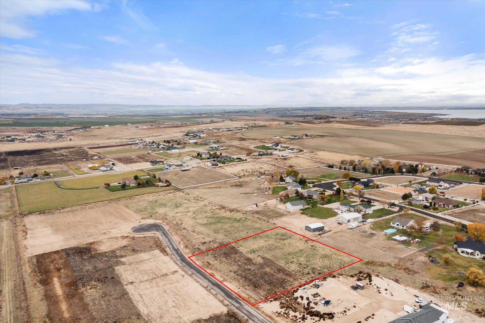 Aerial view of sparsely populated area featuring property parcel outlined