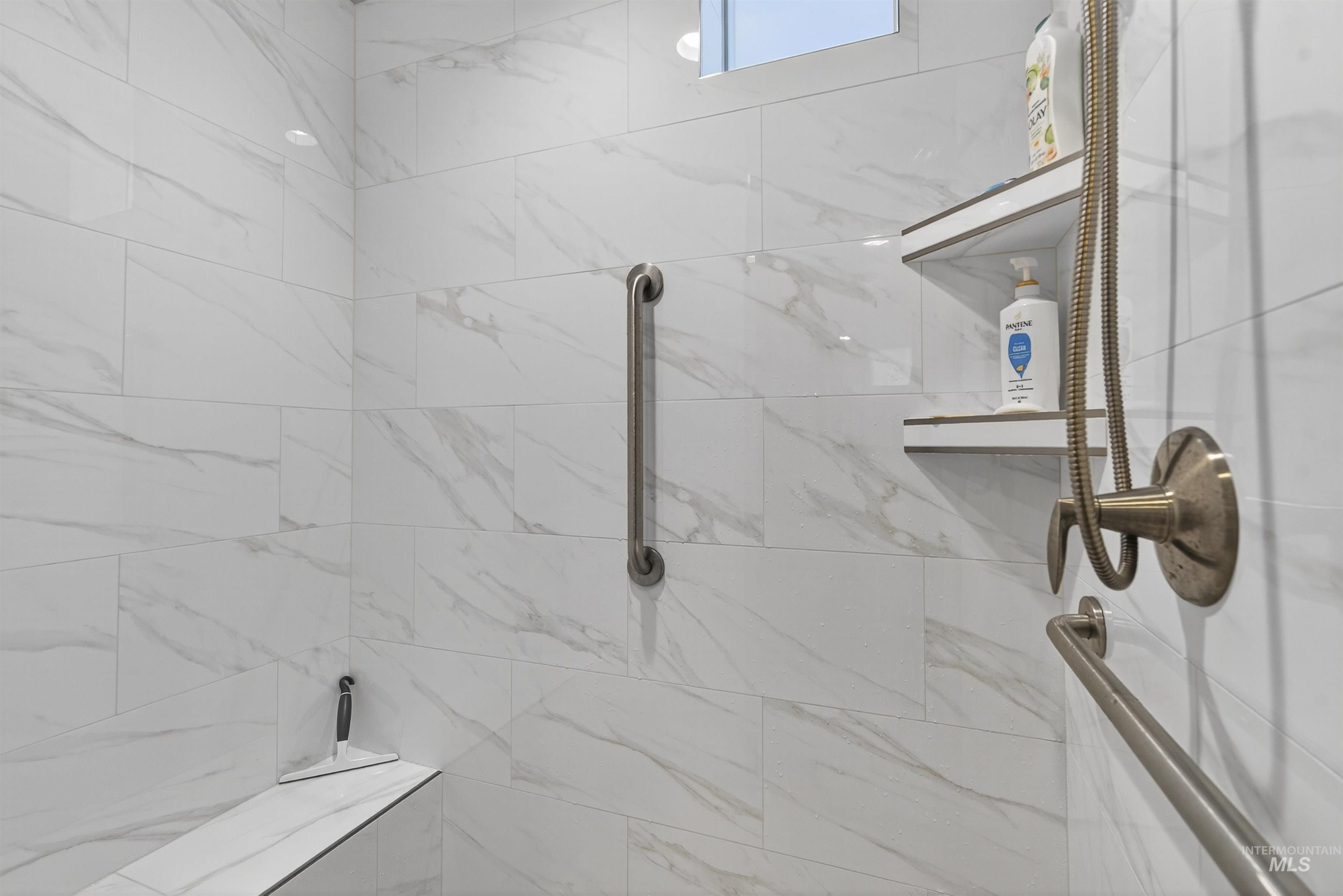 Bathroom with a marble finish shower