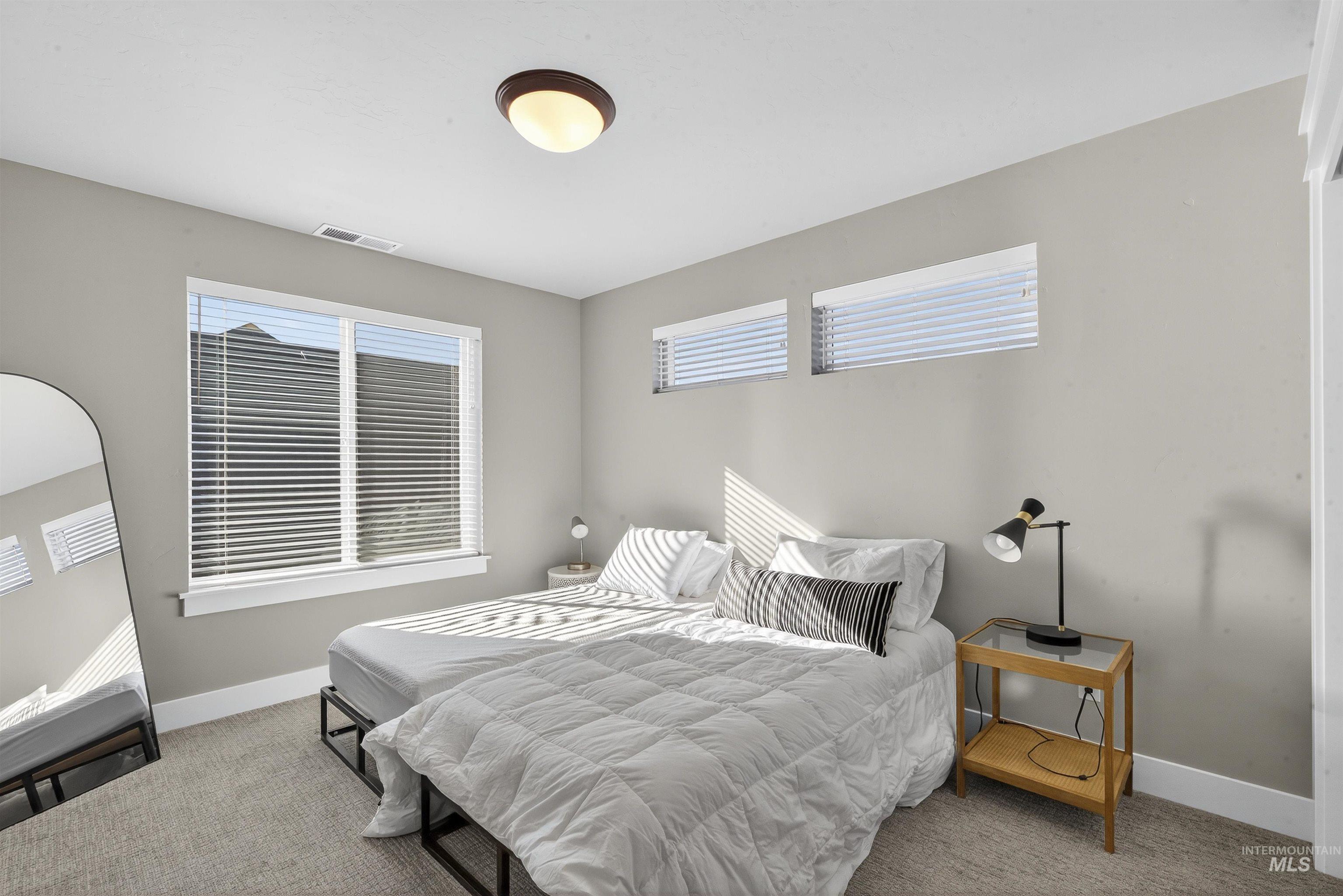 Bedroom with carpet floors and baseboards