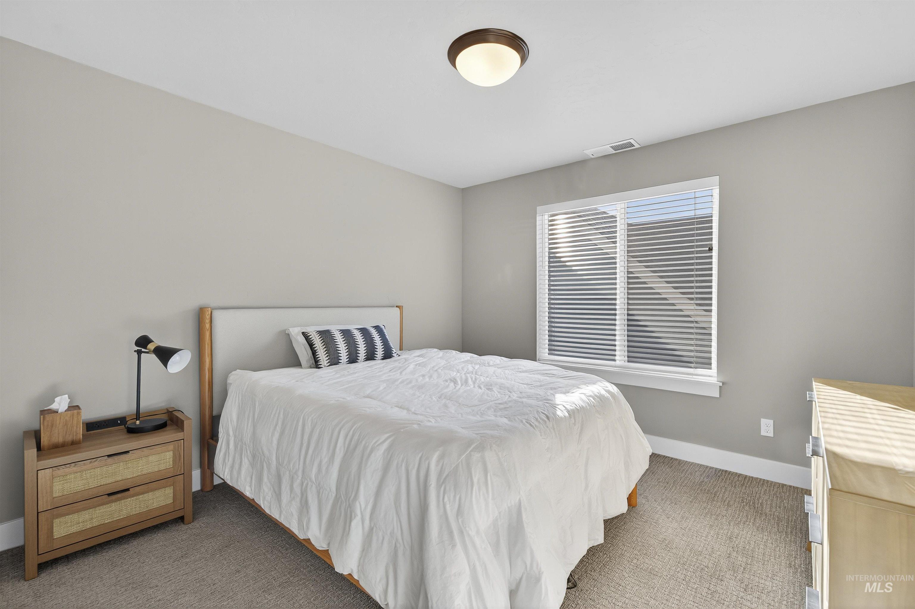 Bedroom with carpet flooring and baseboards