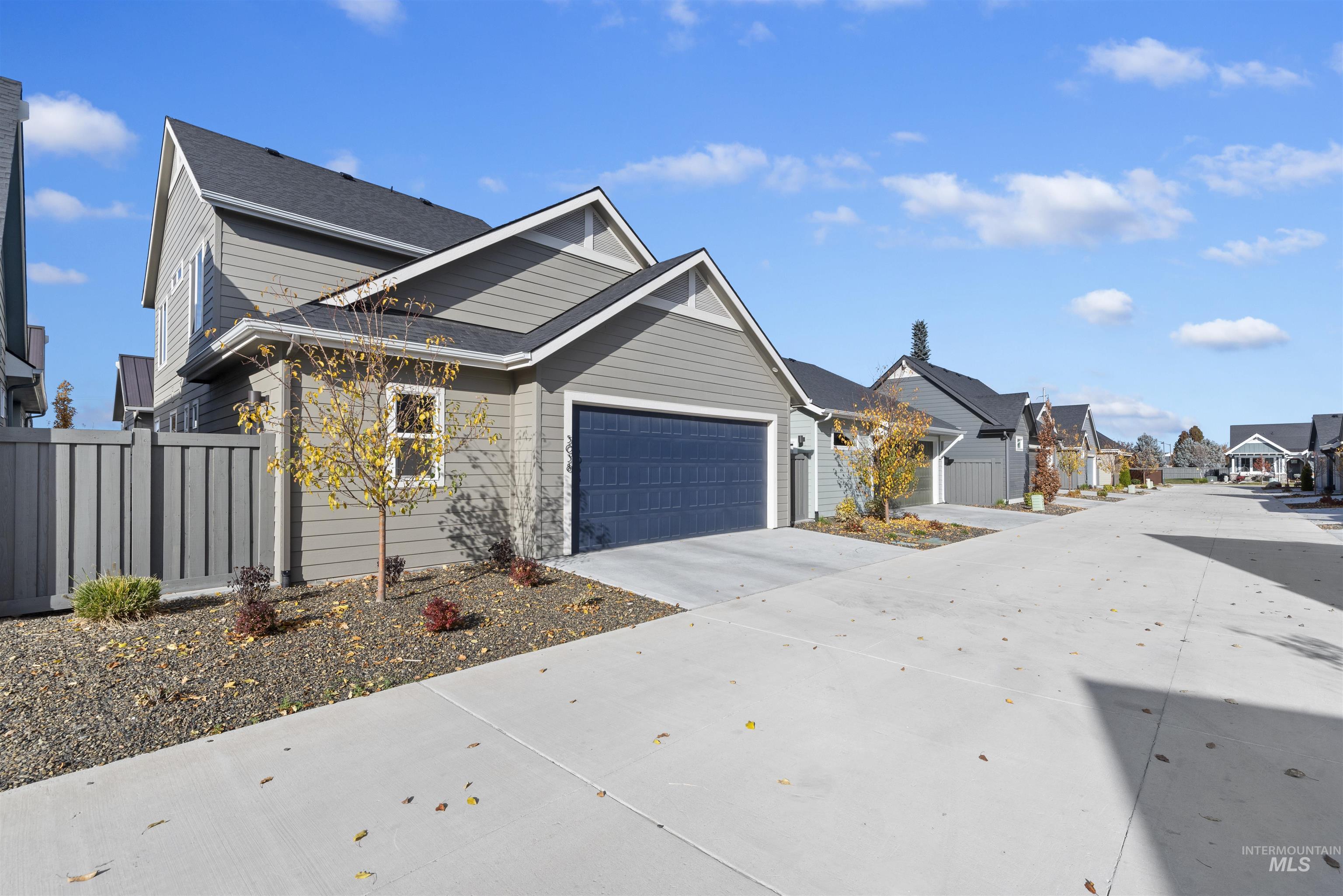 View of home's exterior with concrete driveway and an attached garage