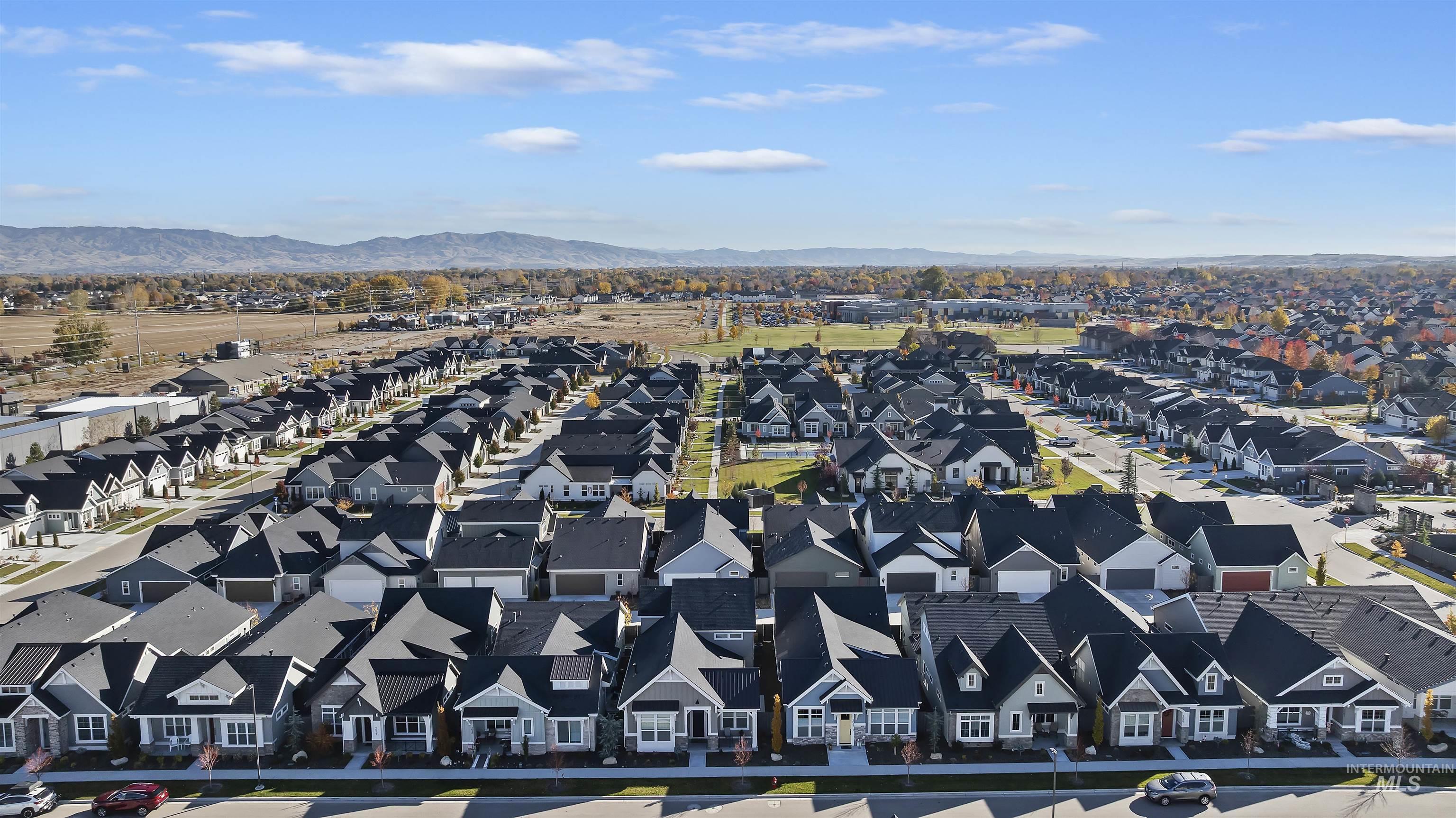 Aerial view of residential area featuring a mountainous background