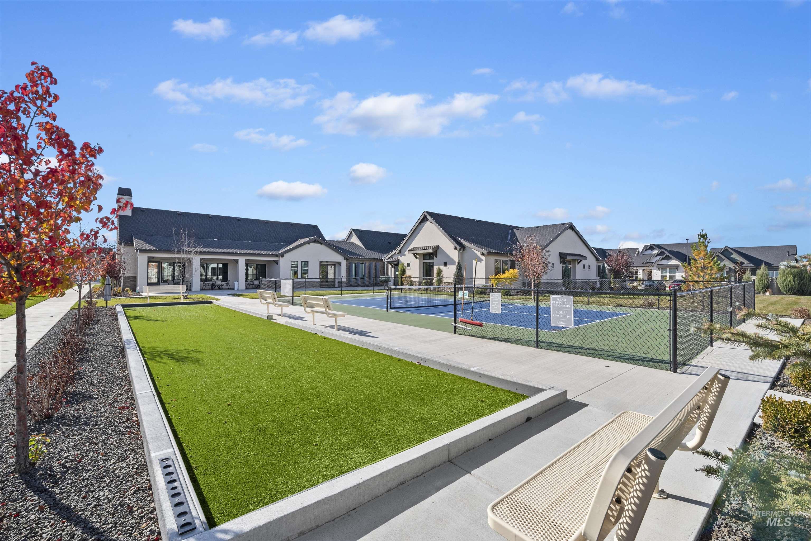 View of community with a tennis court, a residential view, and a game area