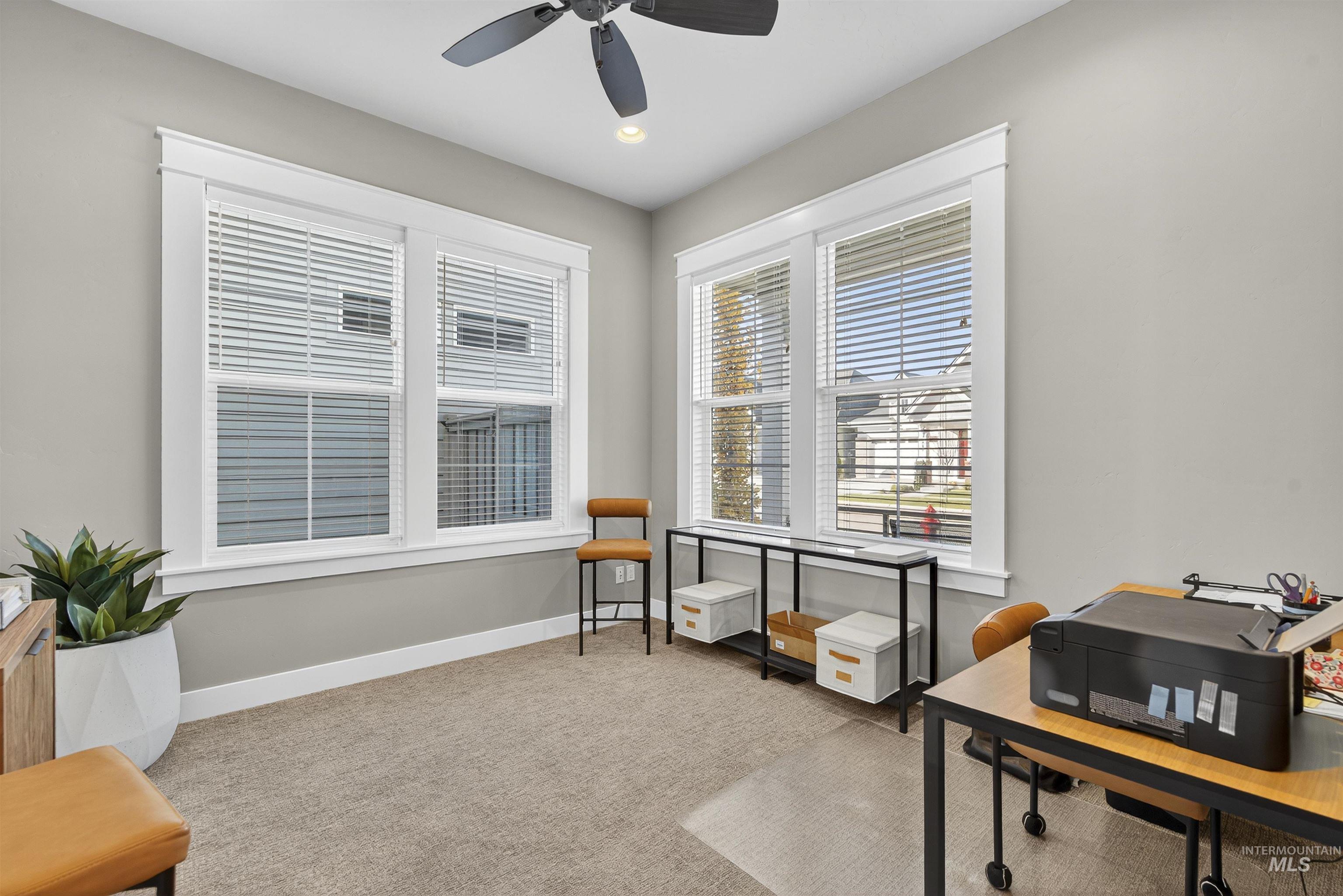 Office featuring light colored carpet and recessed lighting