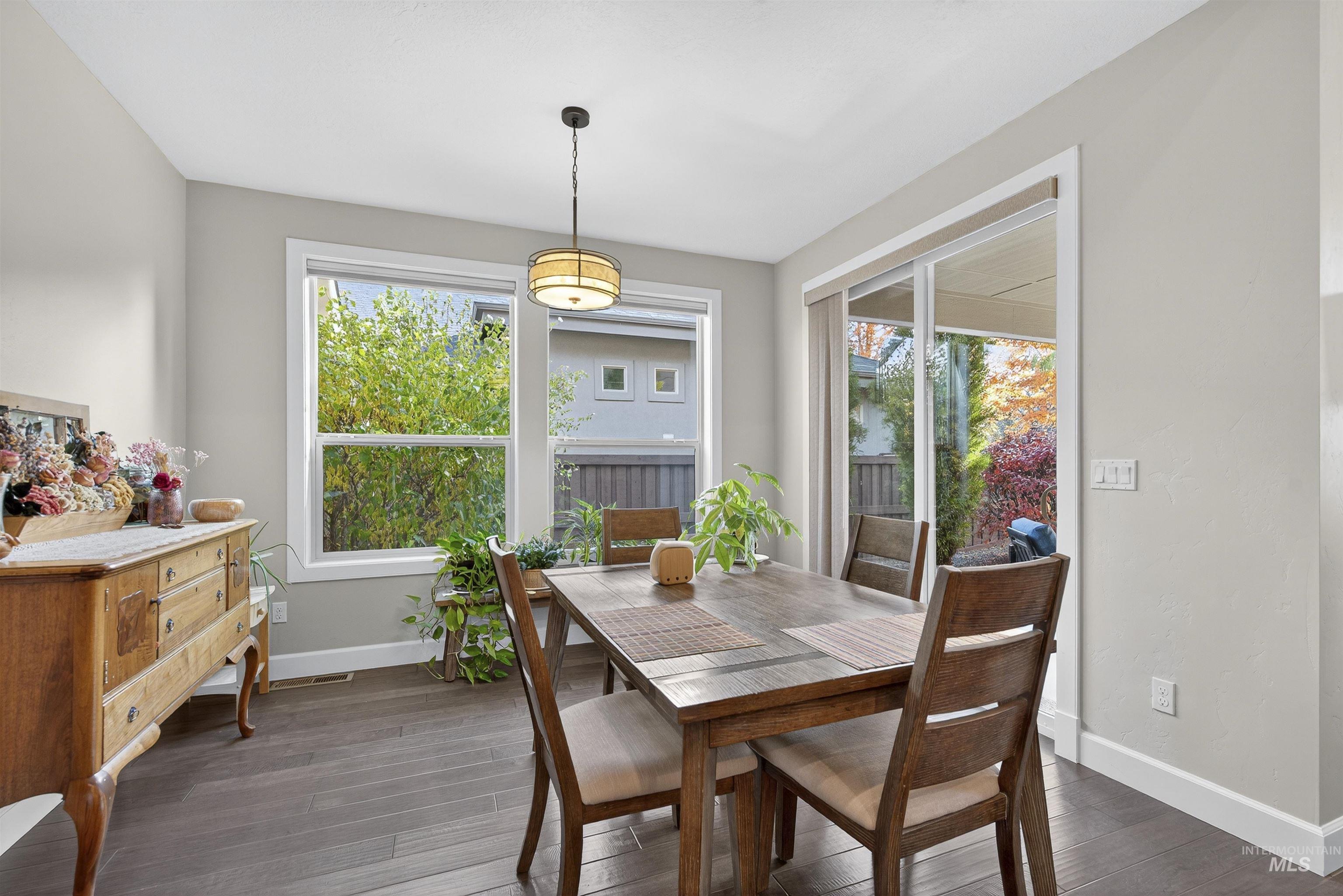Dining area with dark wood-style floors
