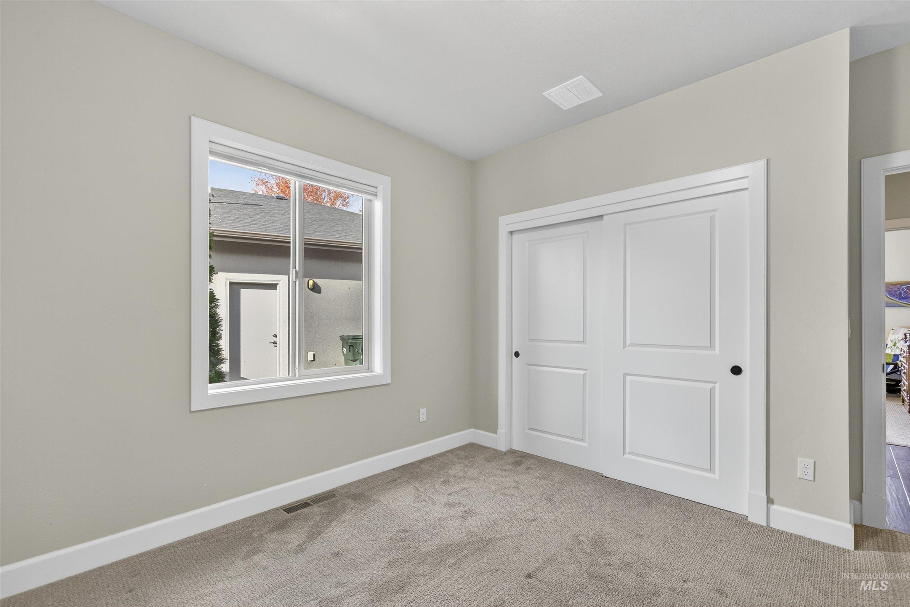 Unfurnished bedroom featuring carpet flooring and a closet