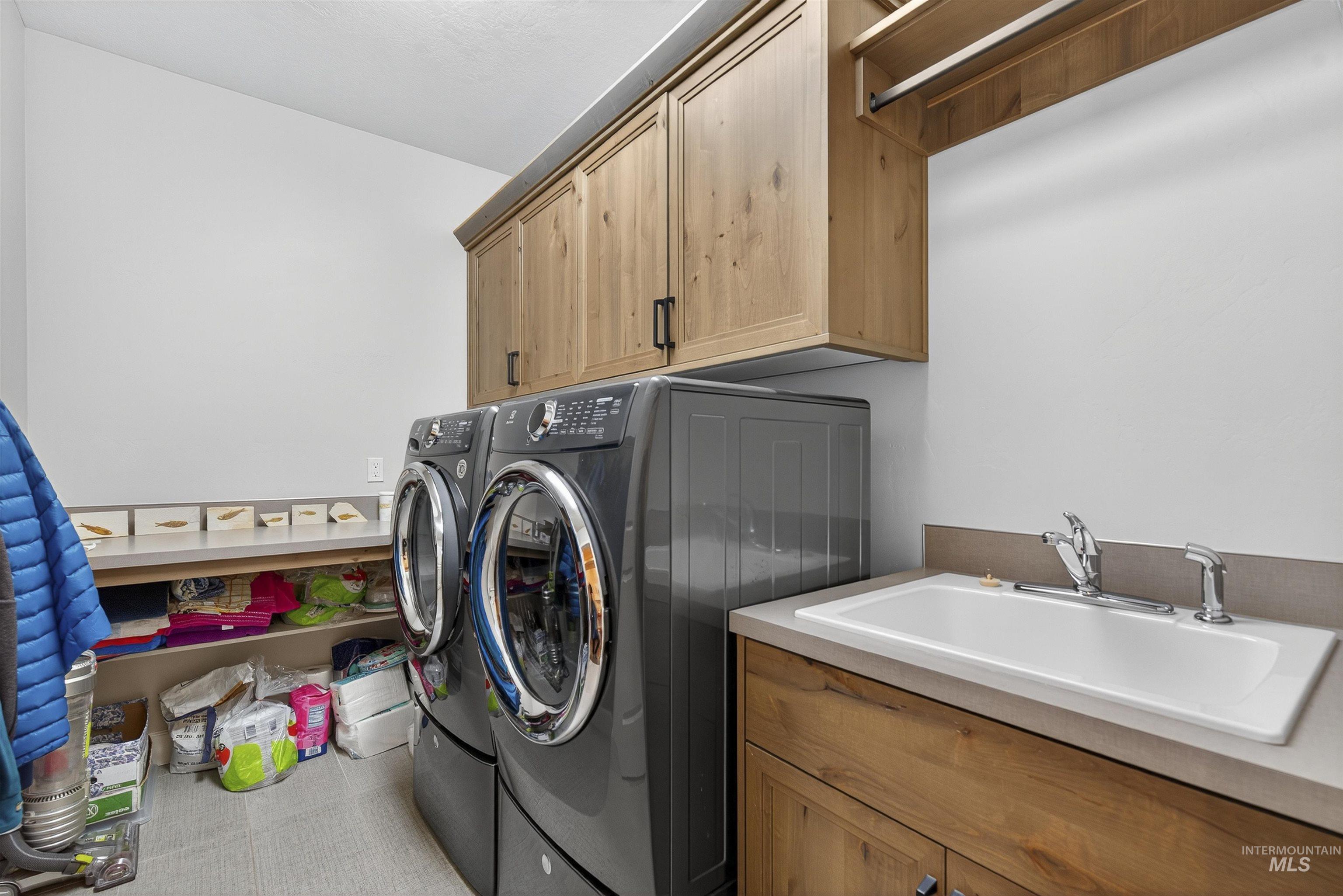 Laundry room with washing machine and dryer and cabinet space