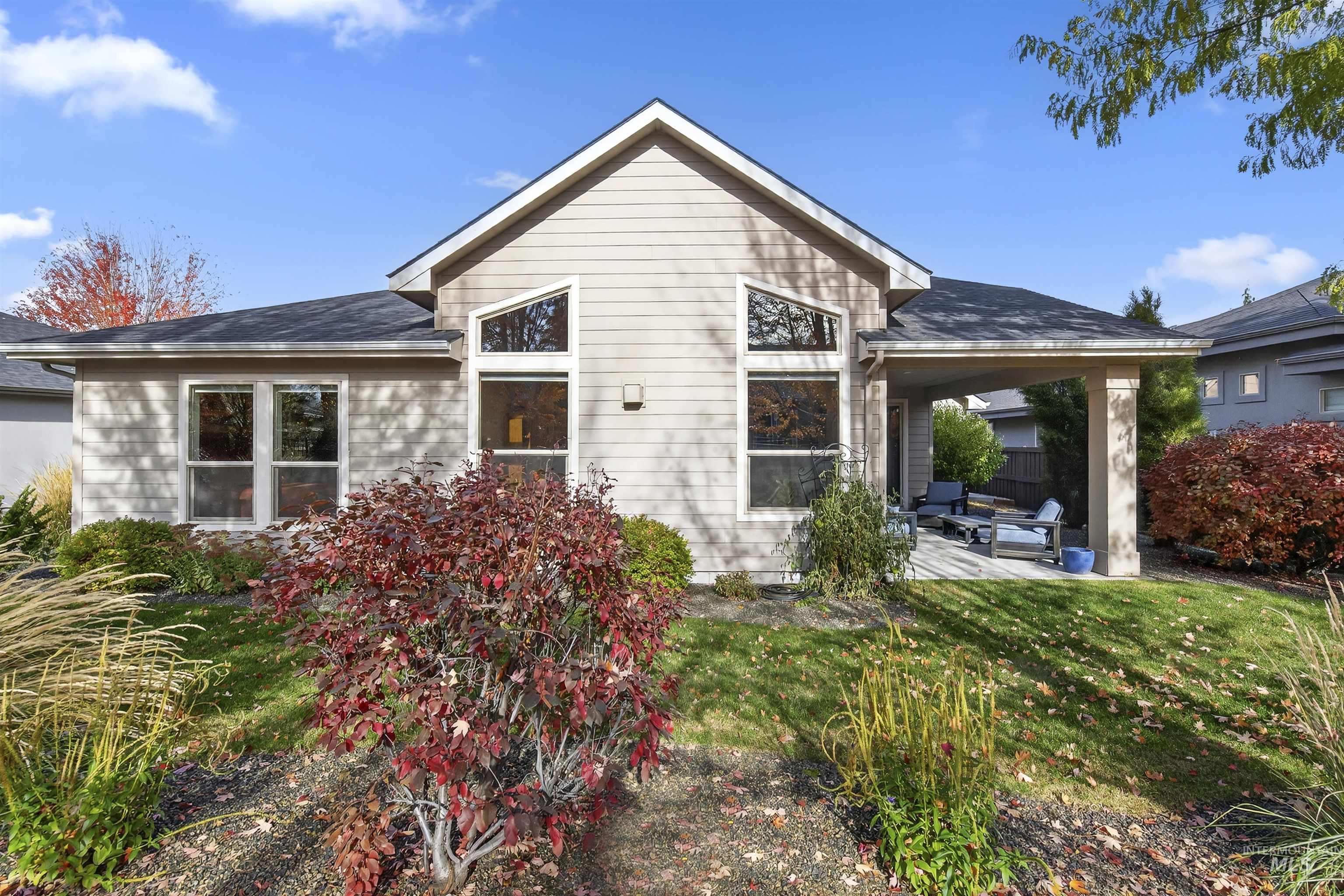 Back of property with a patio and a lawn