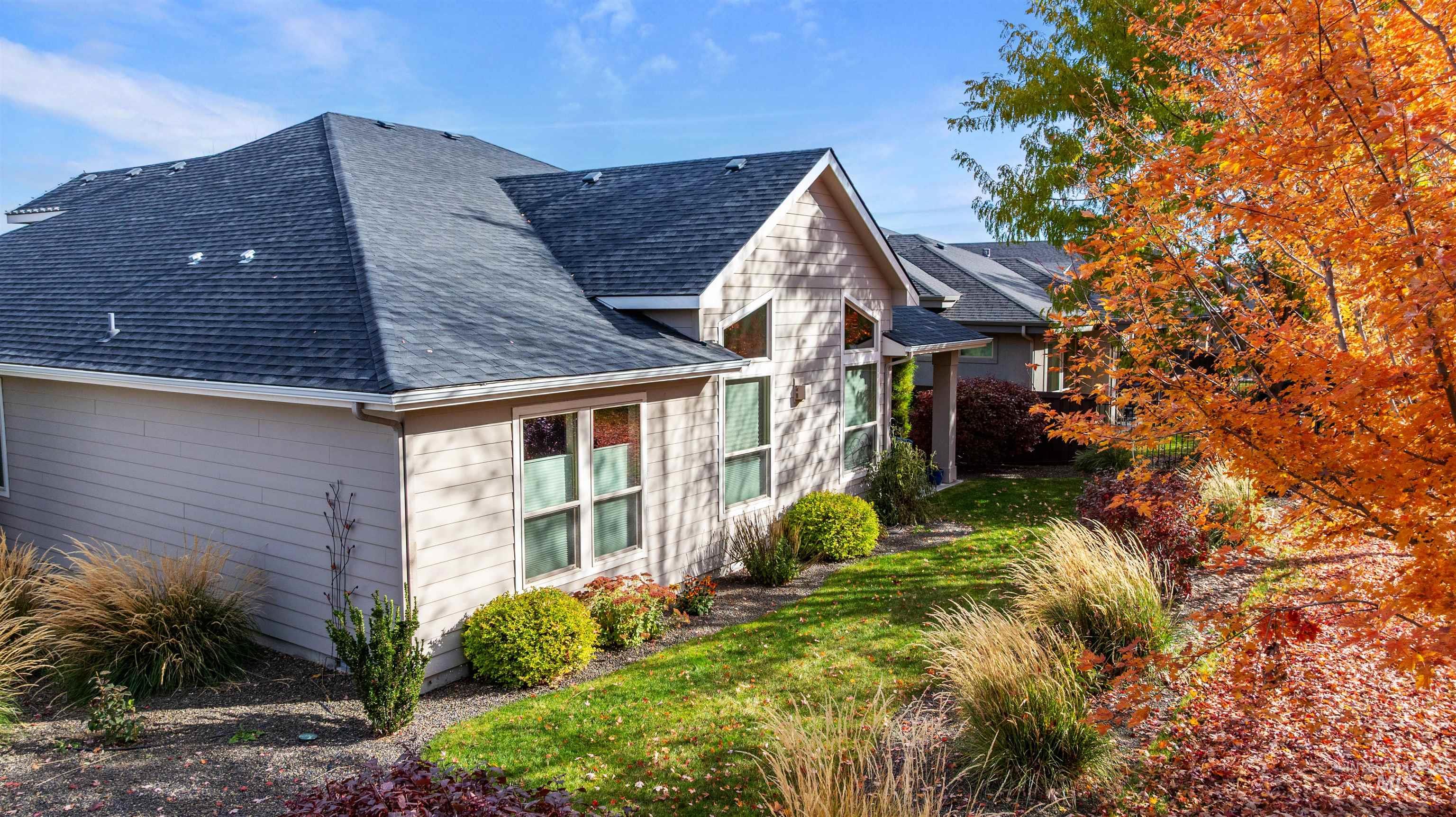 View of home's exterior with roof with shingles and a lawn