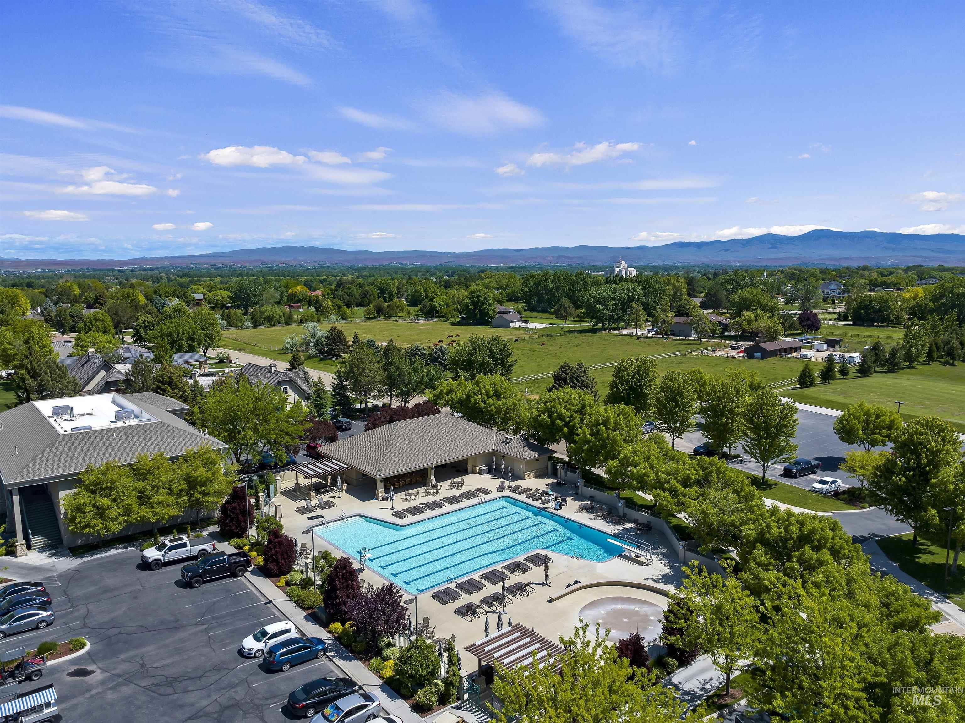 Drone / aerial view of a pool area and a mountain backdrop