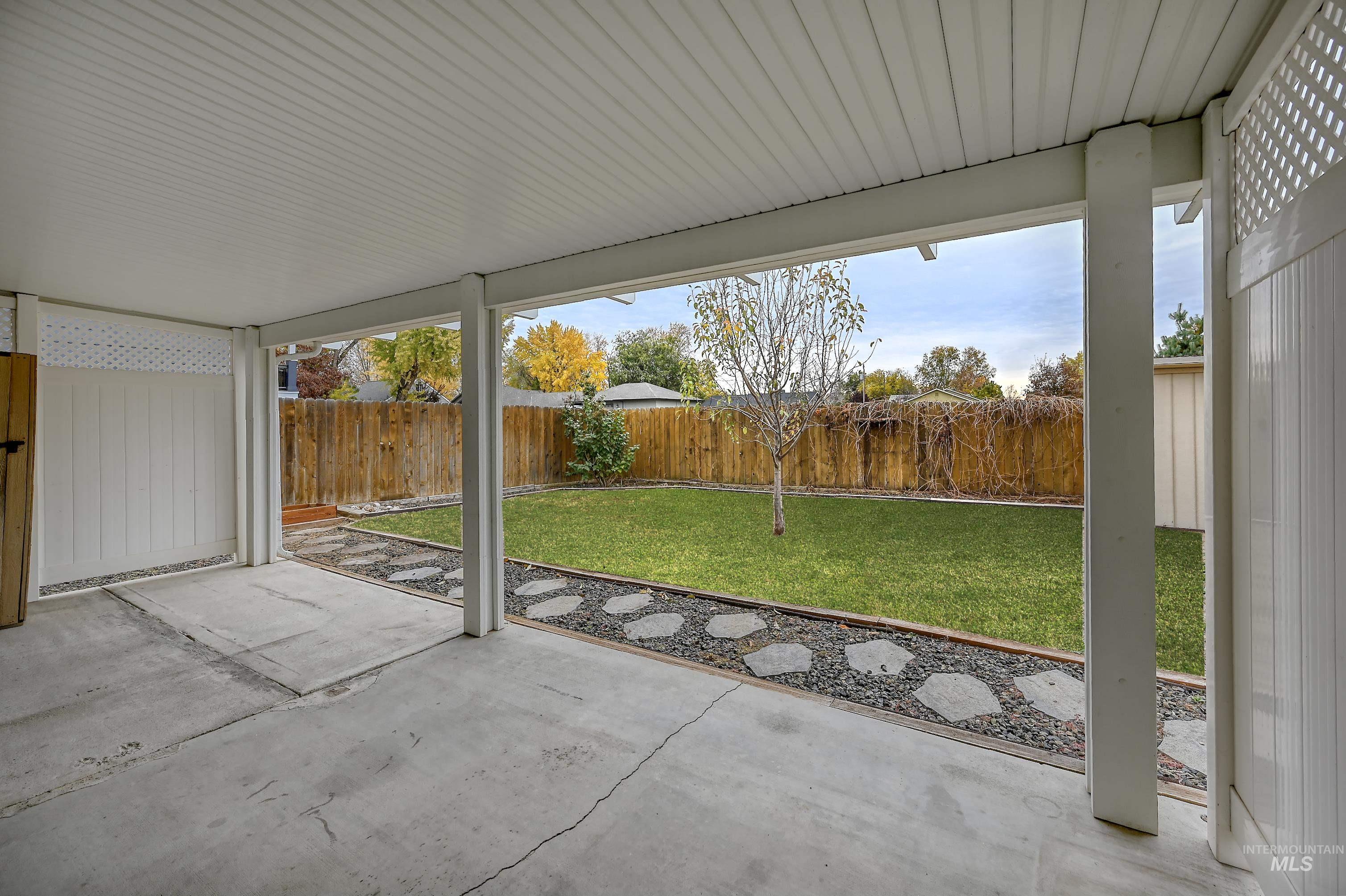Fenced backyard with a patio