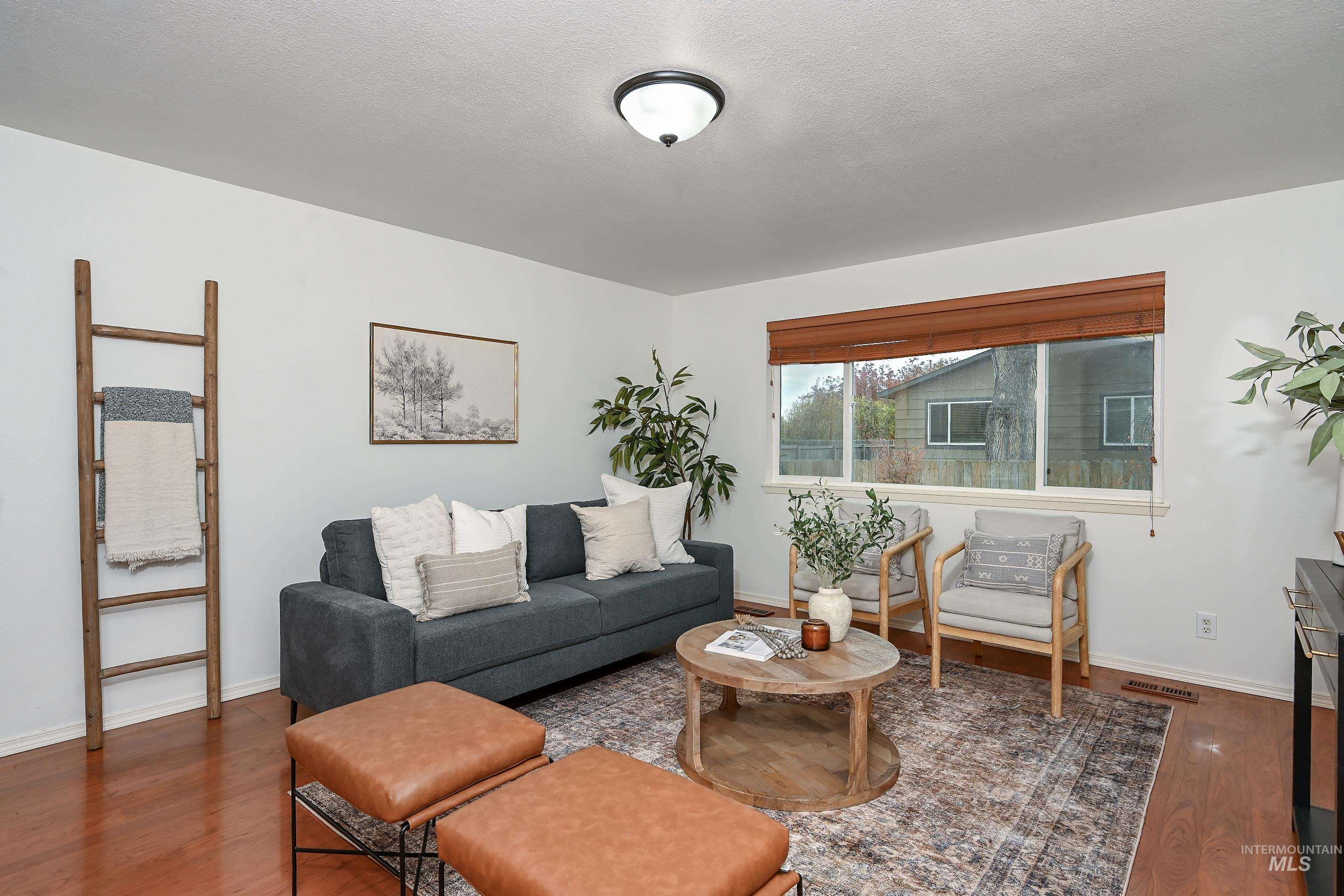 Living area with wood finished floors and a textured ceiling