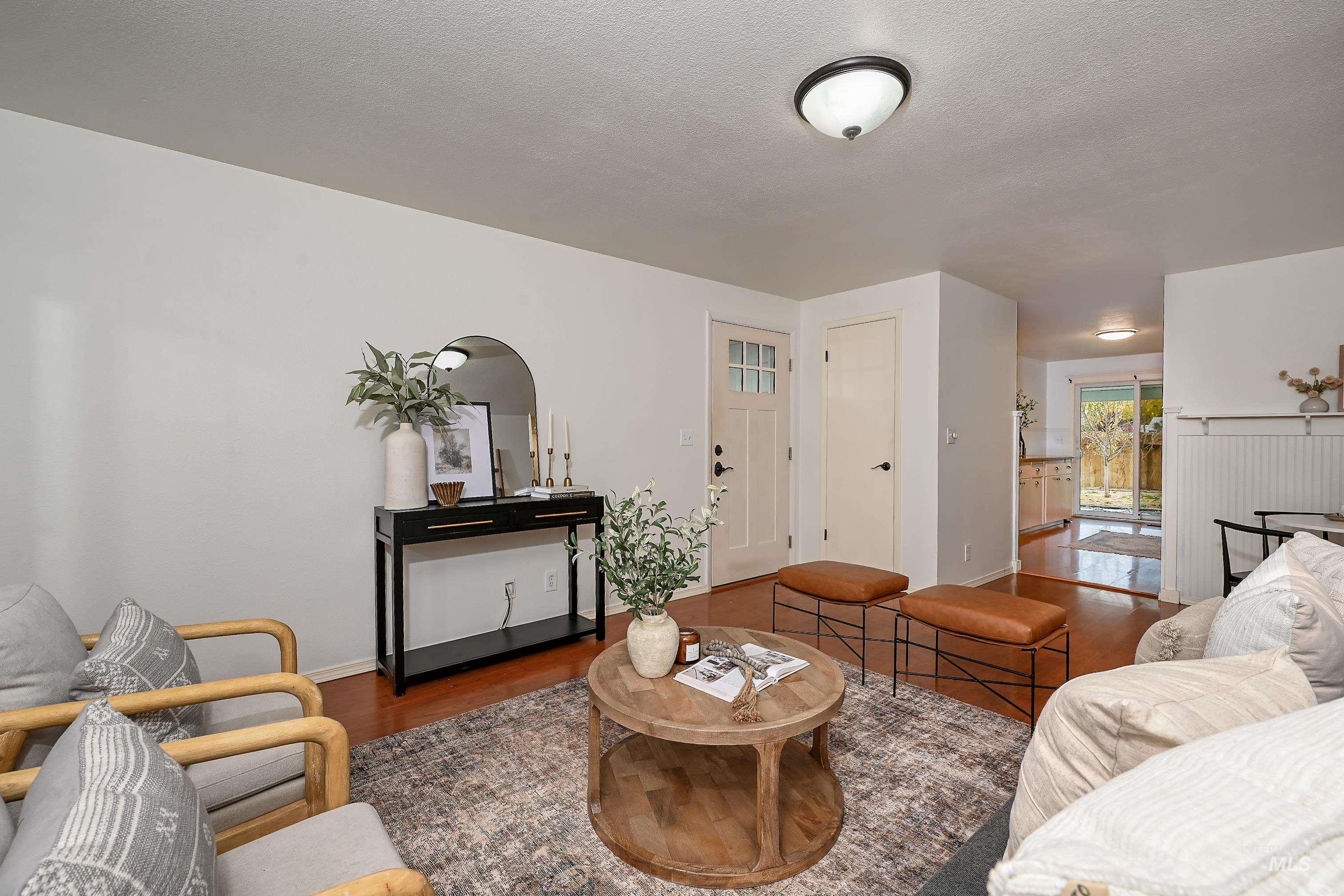 Living room featuring wood finished floors and a textured ceiling