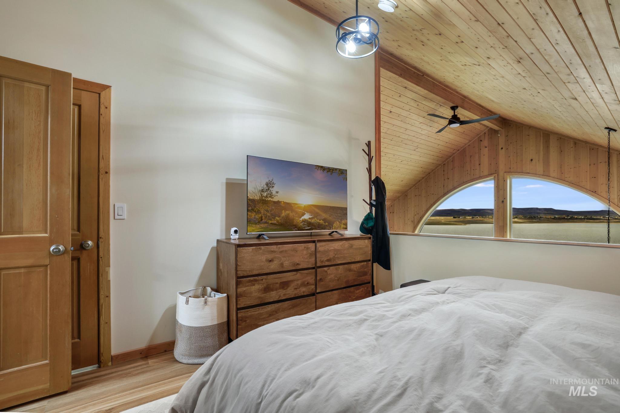 Bedroom featuring wooden ceiling and light wood-style floors