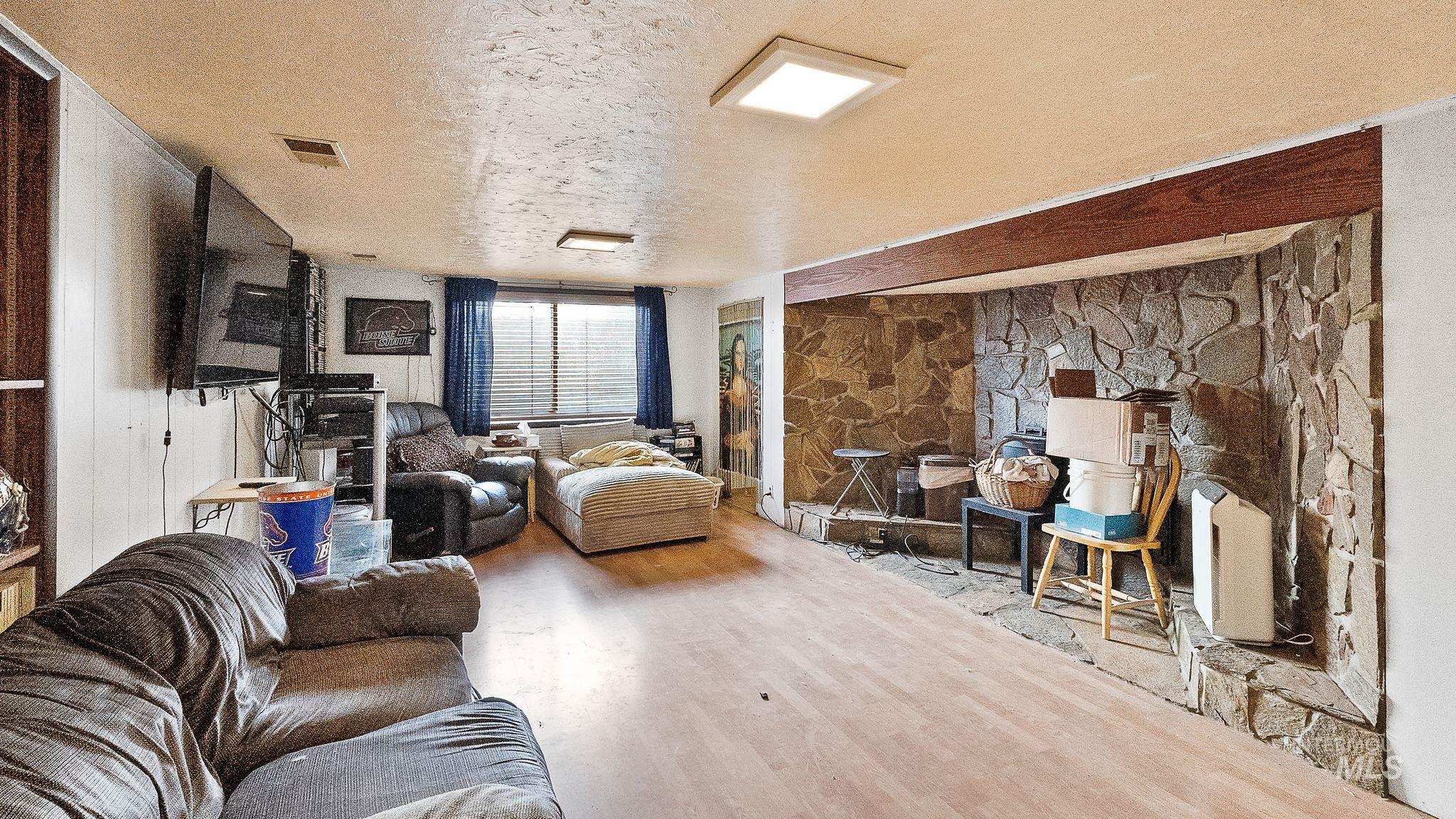 Living area featuring a textured ceiling and wood finished floors