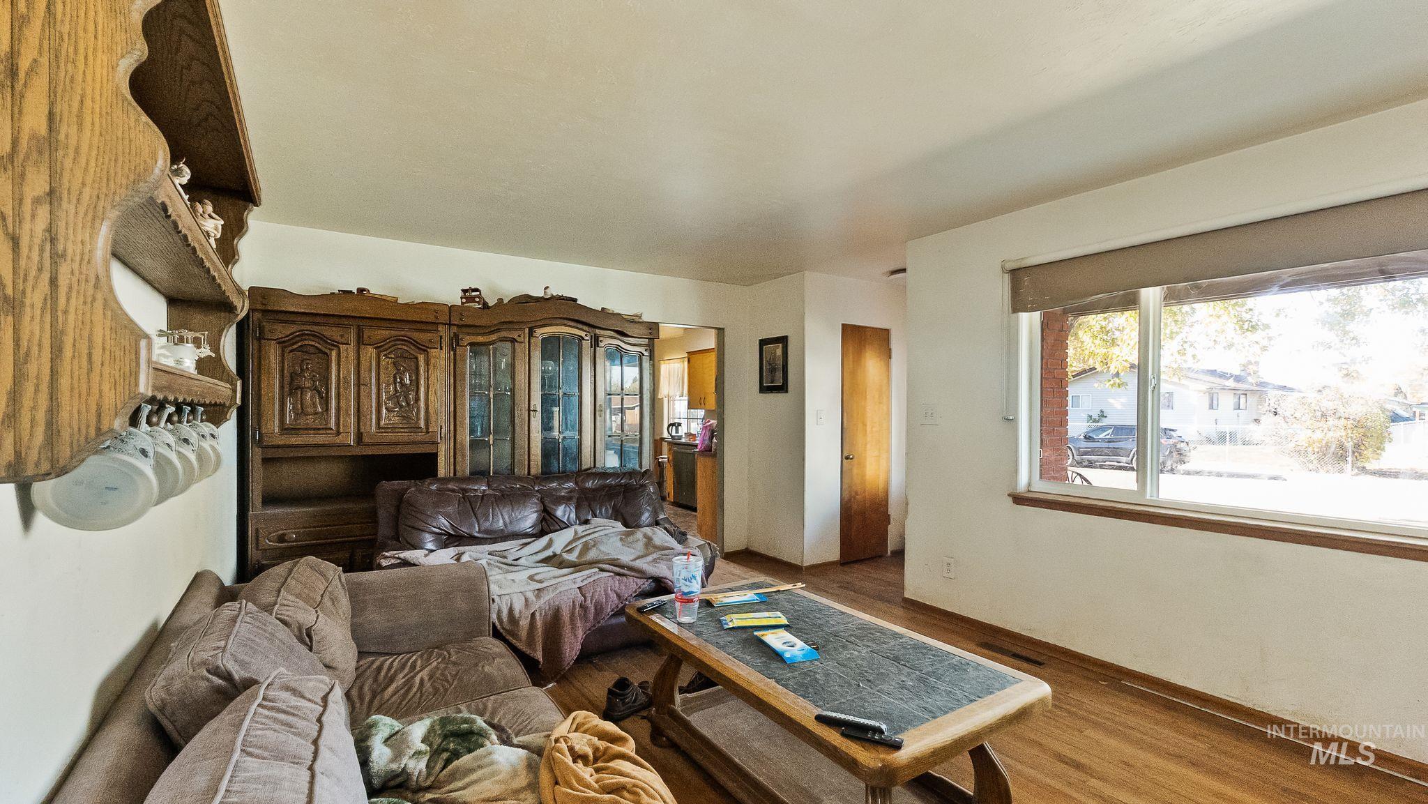 Living area with wood finished floors and baseboards