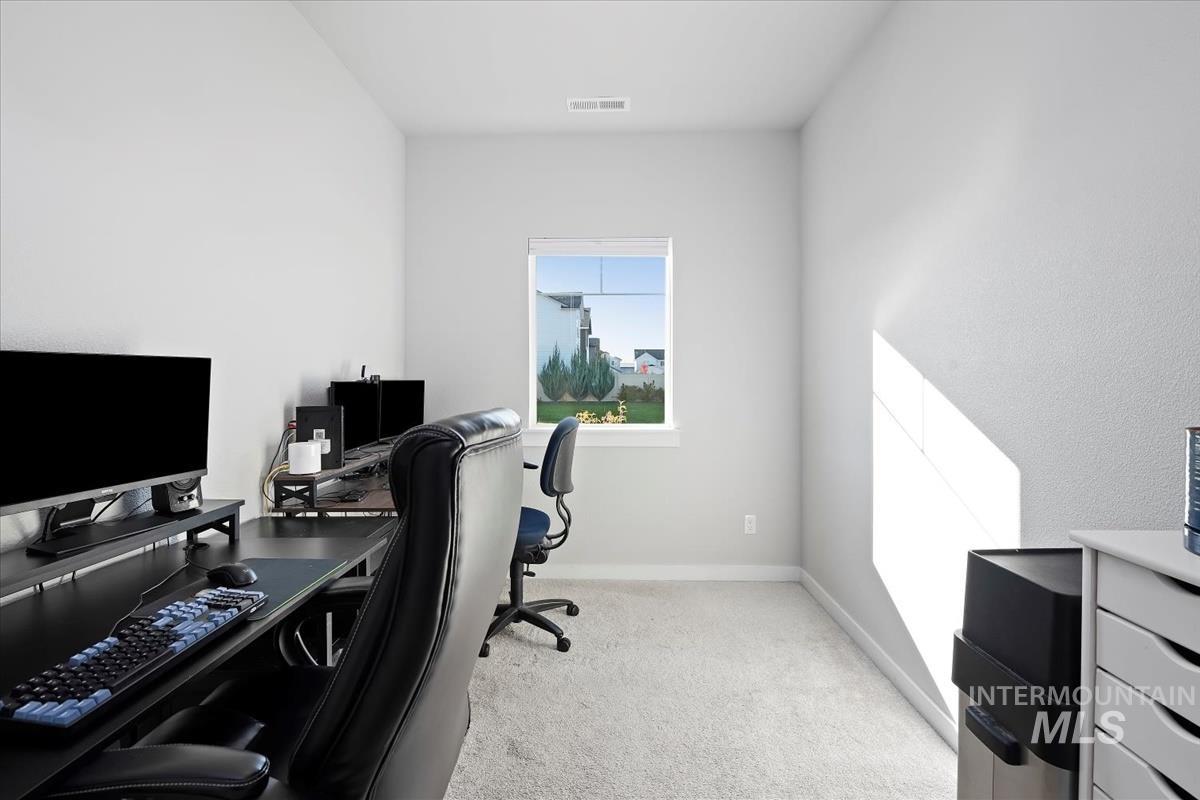 Office featuring baseboards and light colored carpet