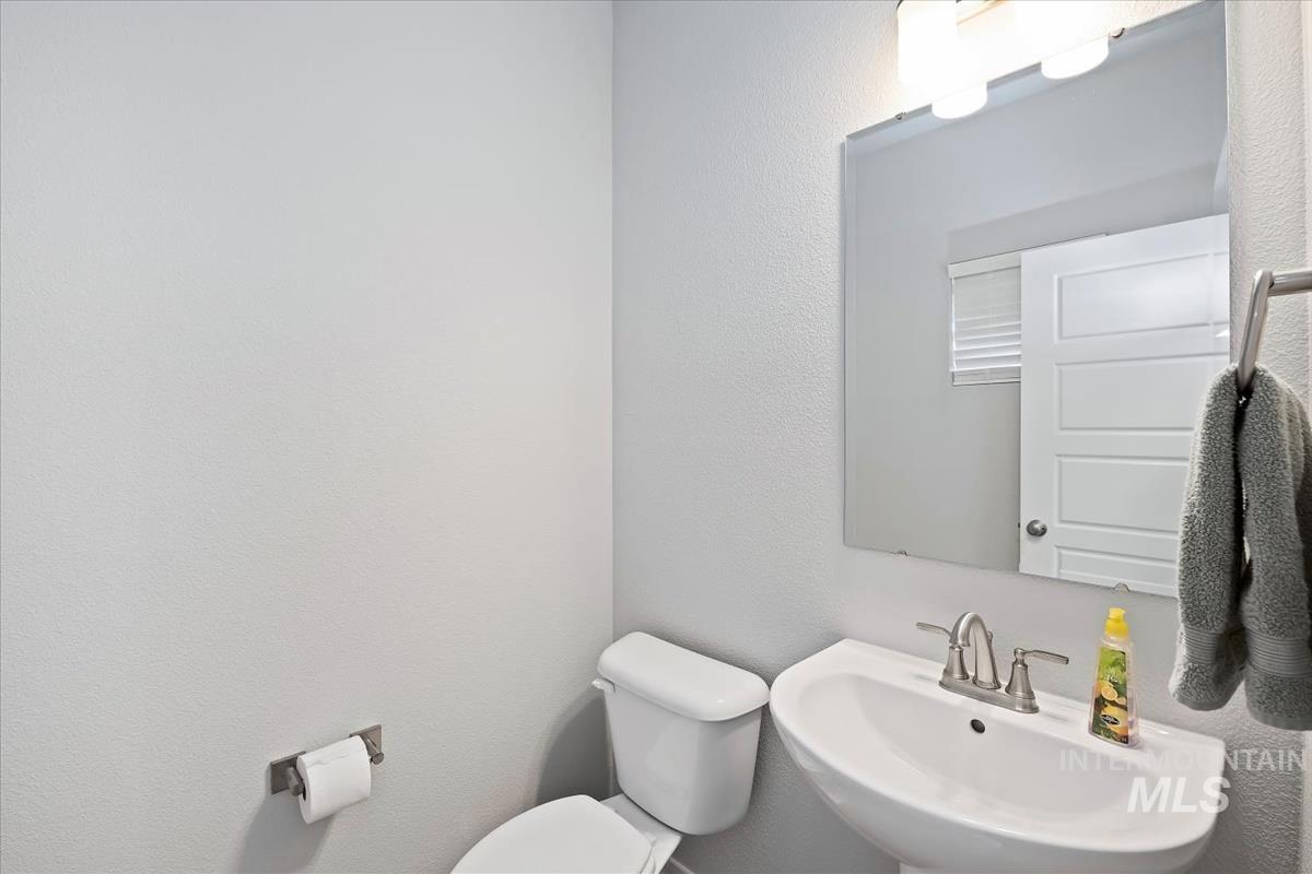Bathroom featuring a textured wall and a sink