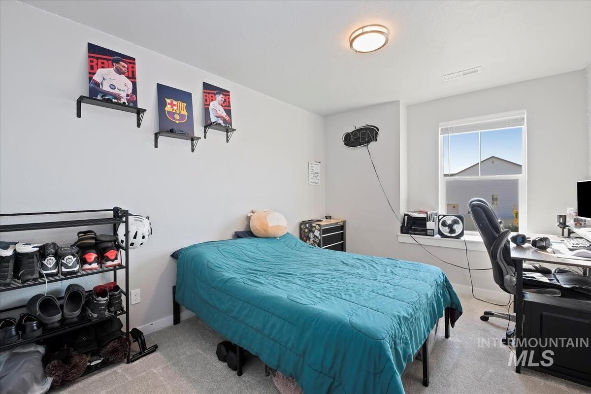 Bedroom featuring an office area and carpet floors