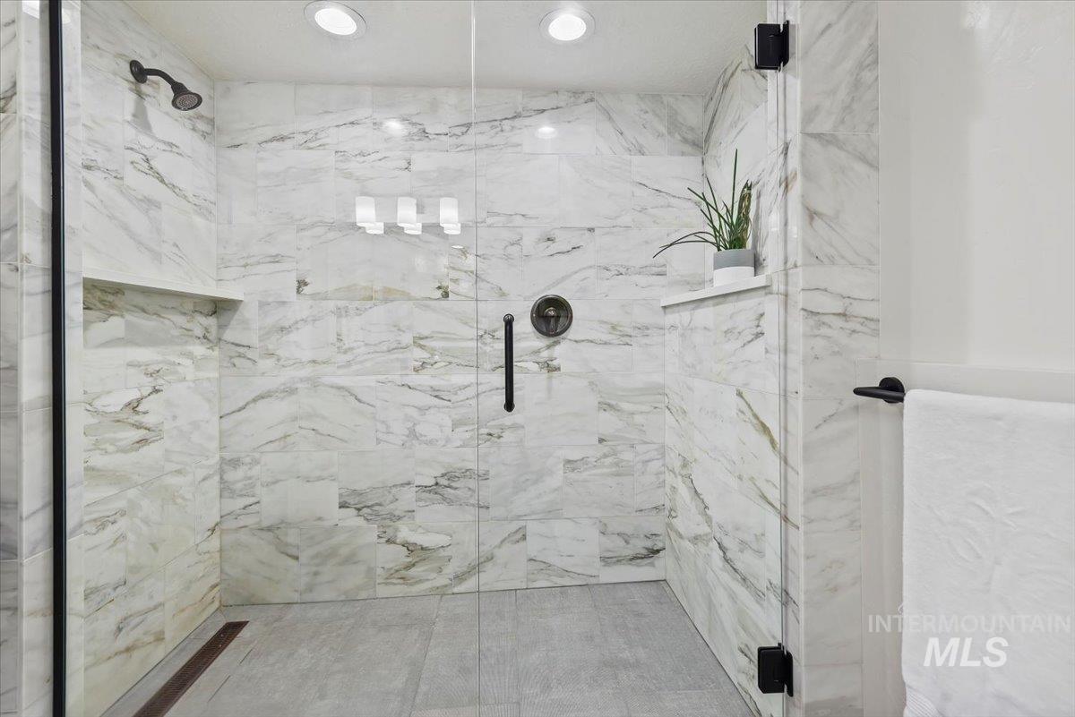 Full bathroom featuring a marble finish shower