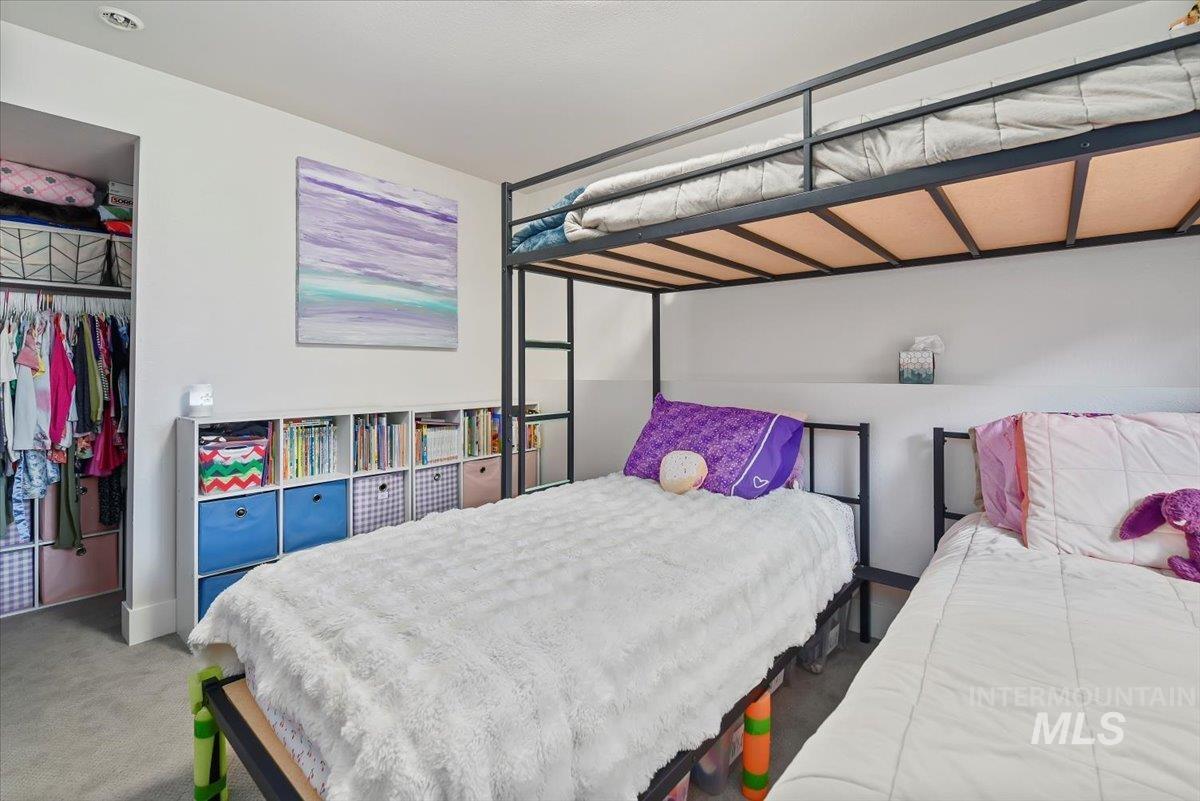 Carpeted bedroom with a closet