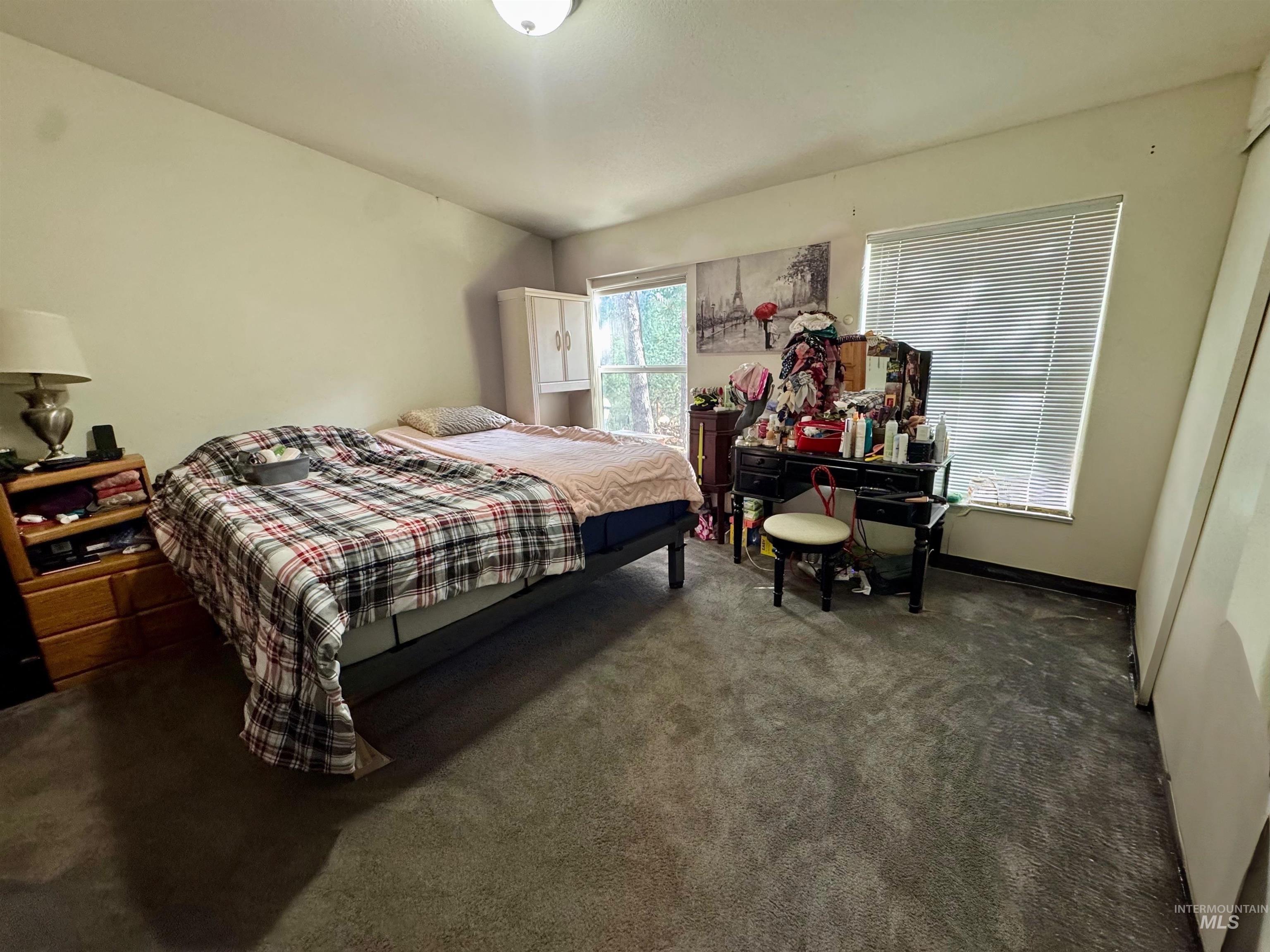 Carpeted bedroom featuring baseboards