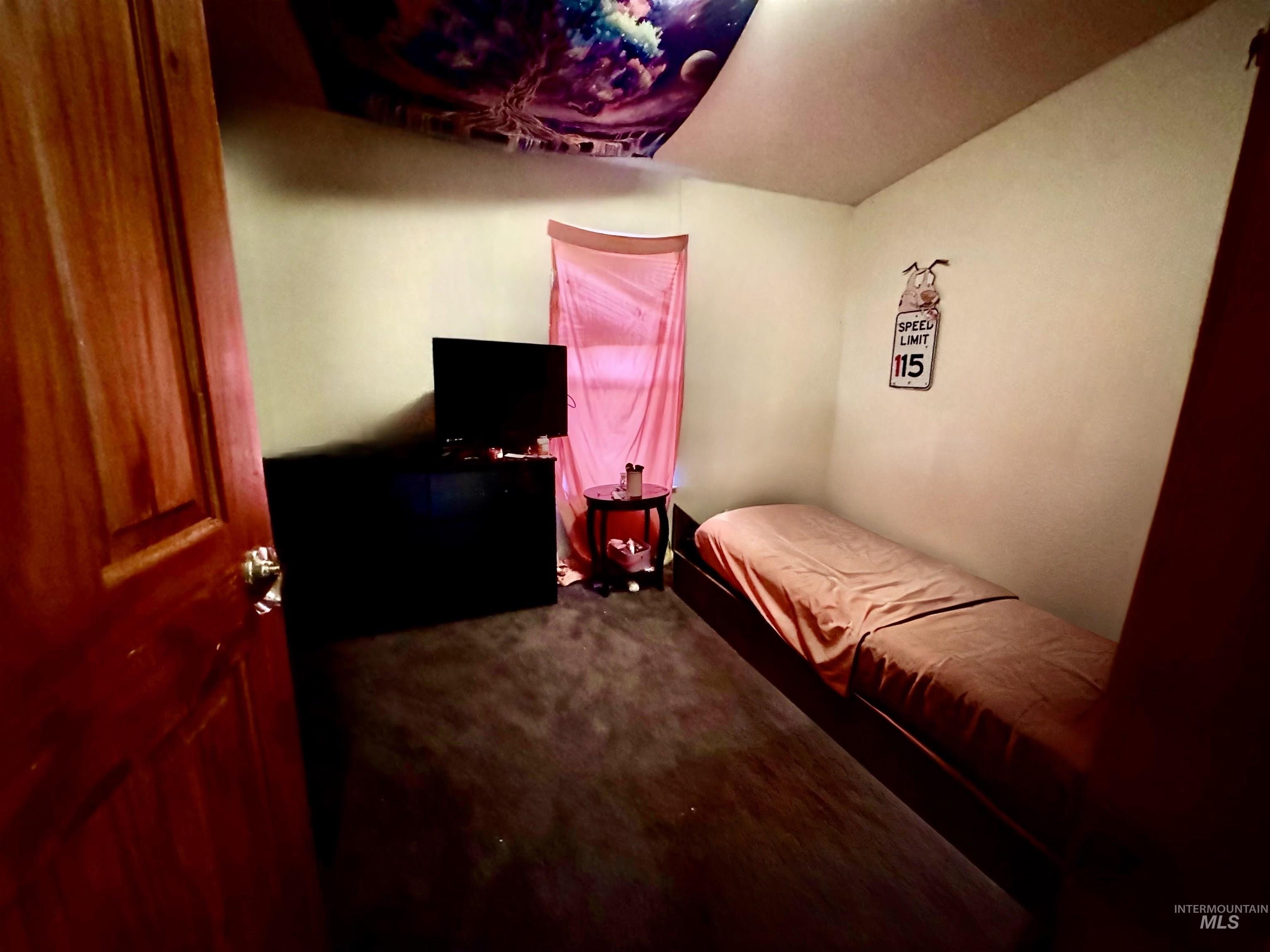 Bedroom featuring dark carpet