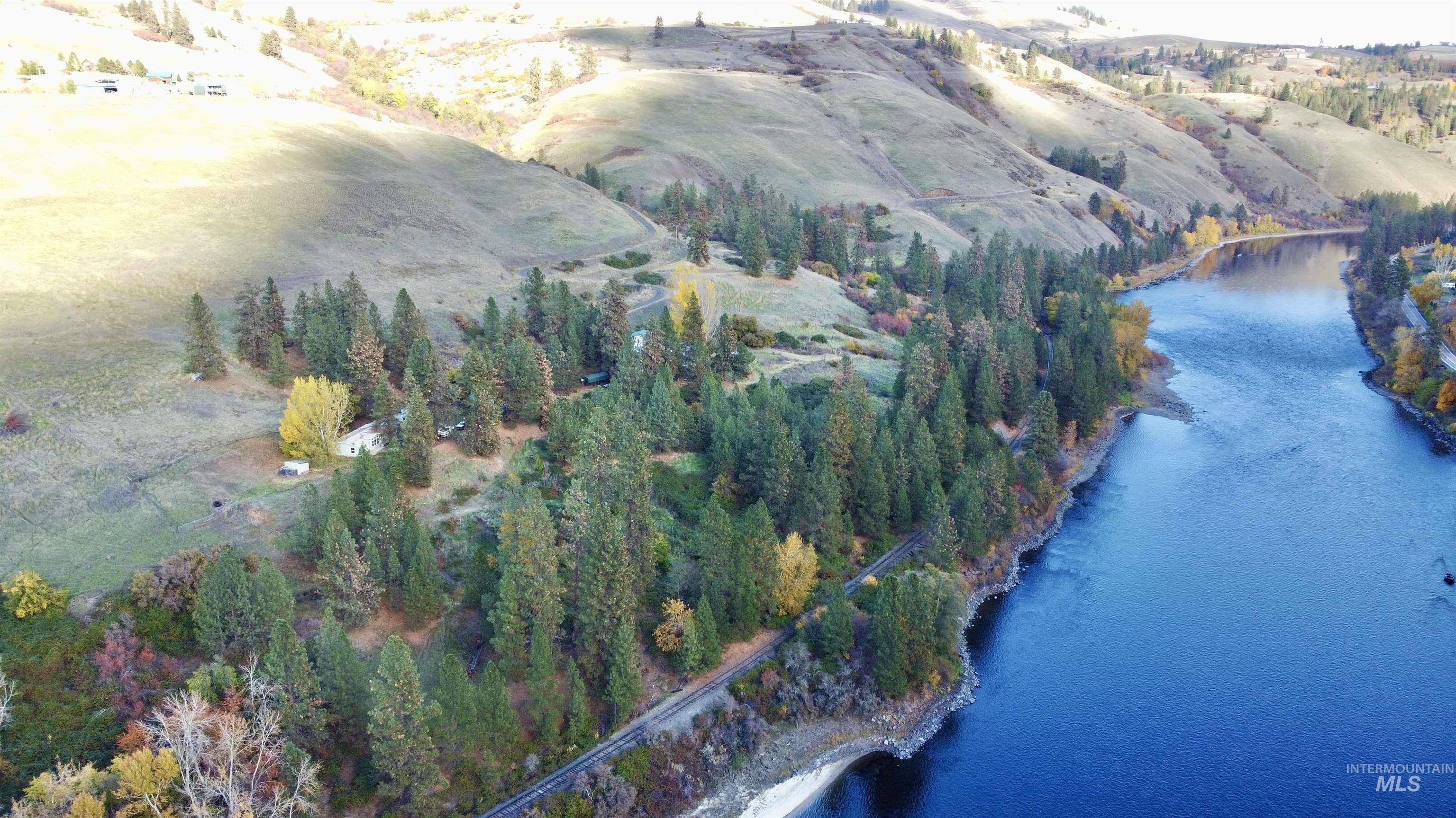 Aerial view of property and surrounding area with a nearby body of water