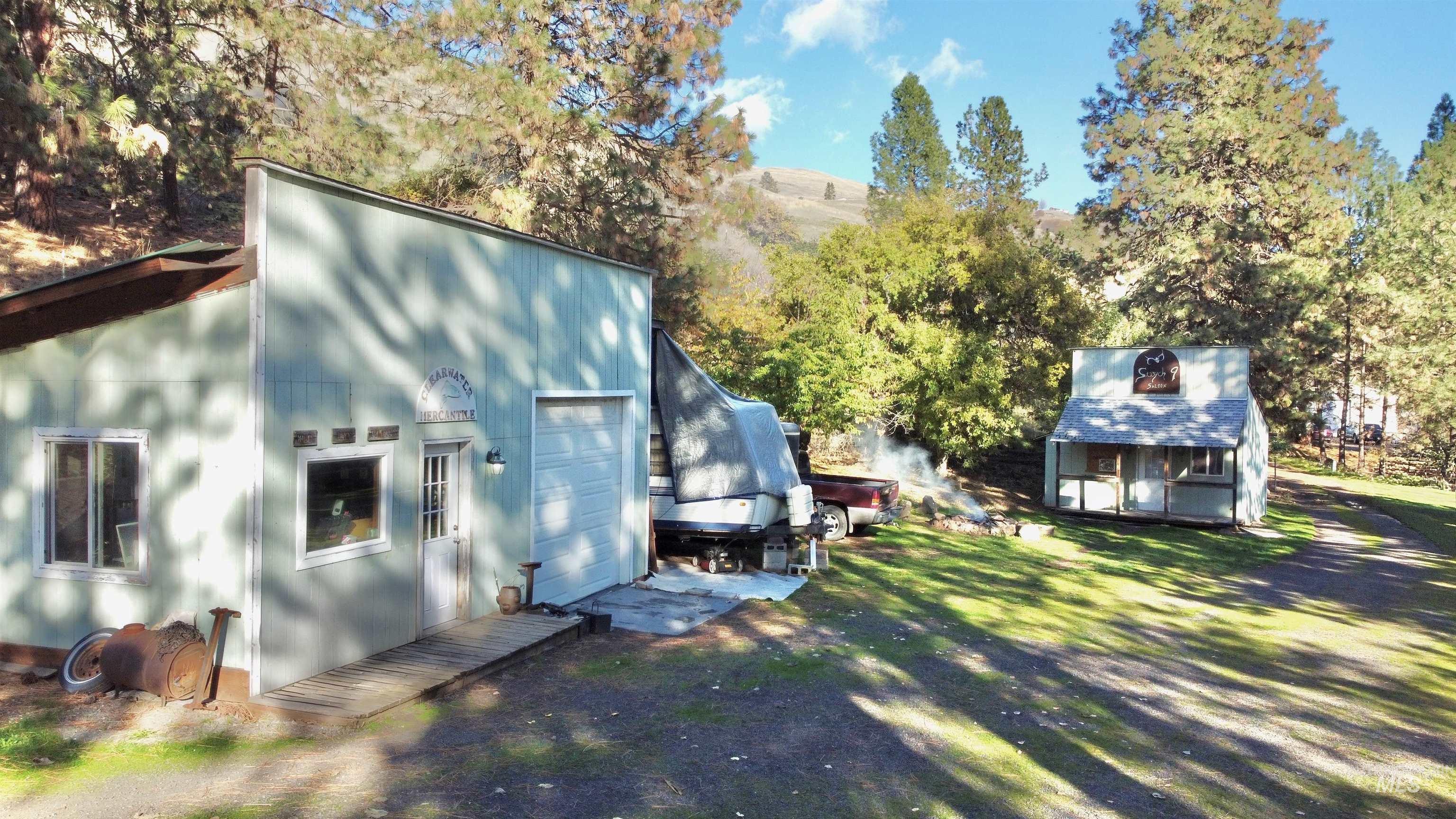 View of side of property featuring an outbuilding and a garage