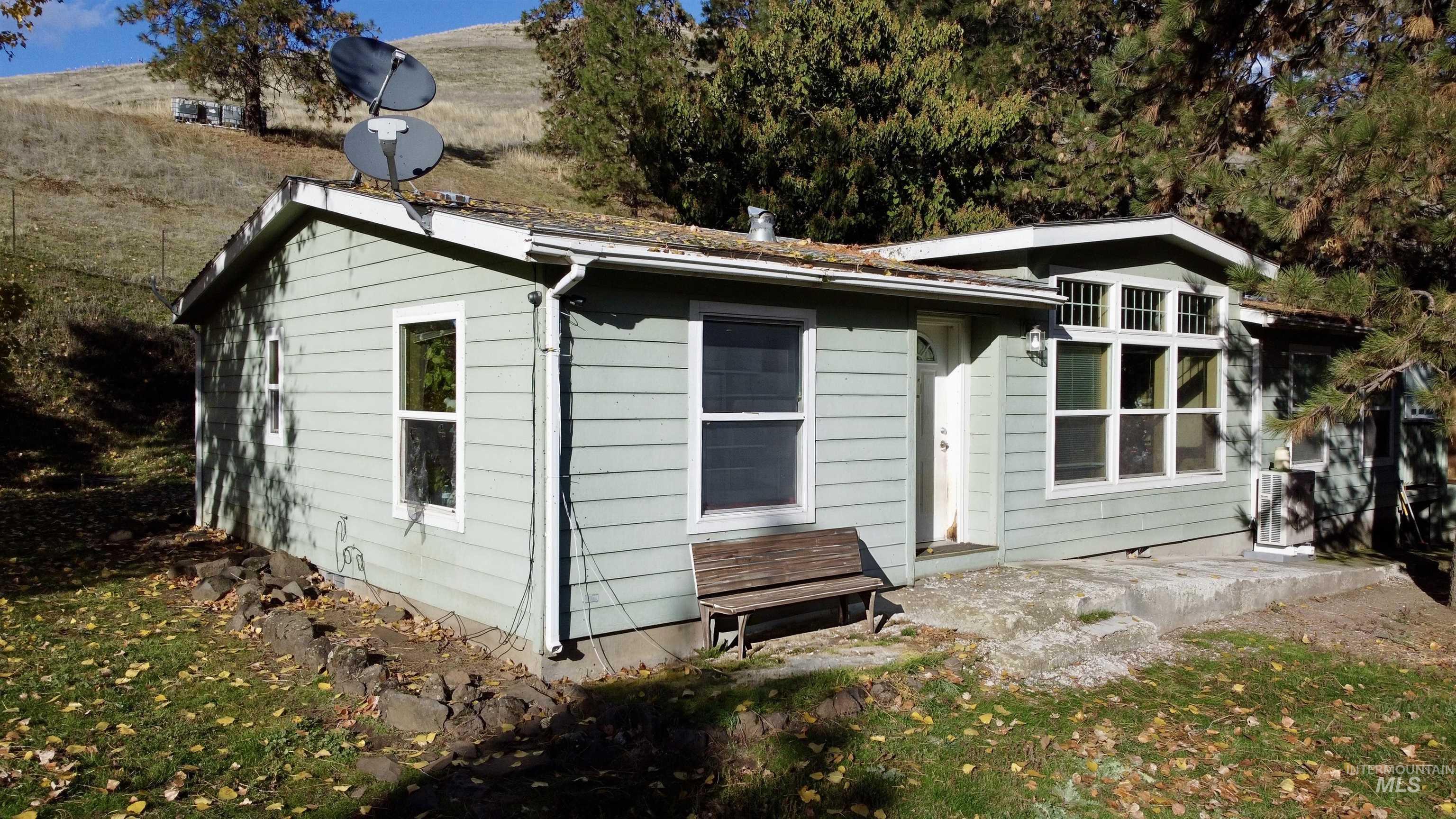View of side of home with a cooling unit and a patio area